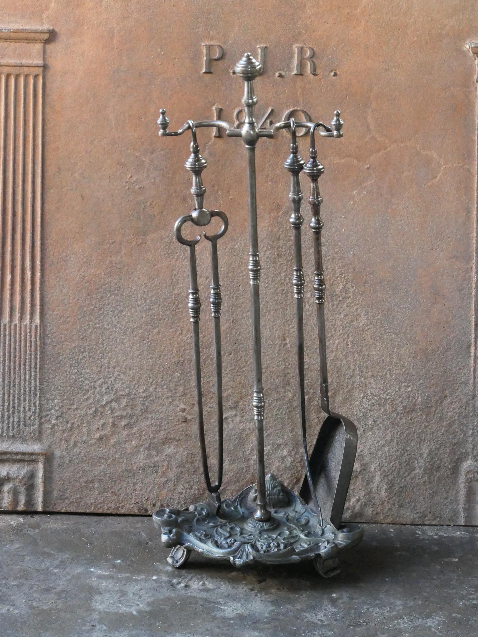 Beautiful 18th century Dutch Louis XV period fireplace toolset made of wrought iron and cast iron. The toolset consists of three fire irons and a stand. The condition is good.








.