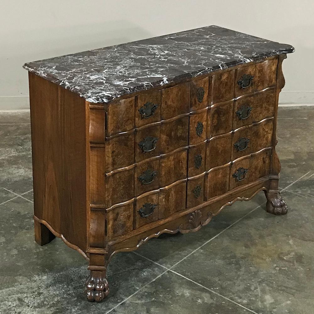 Antique Dutch marble-top silver chest features a beautifully contoured facade enhanced by the intricate grain of the burl walnut accentuated by brass key guards and drawer pulls. A shell carved on the contoured apron leads the eye to the mitered
