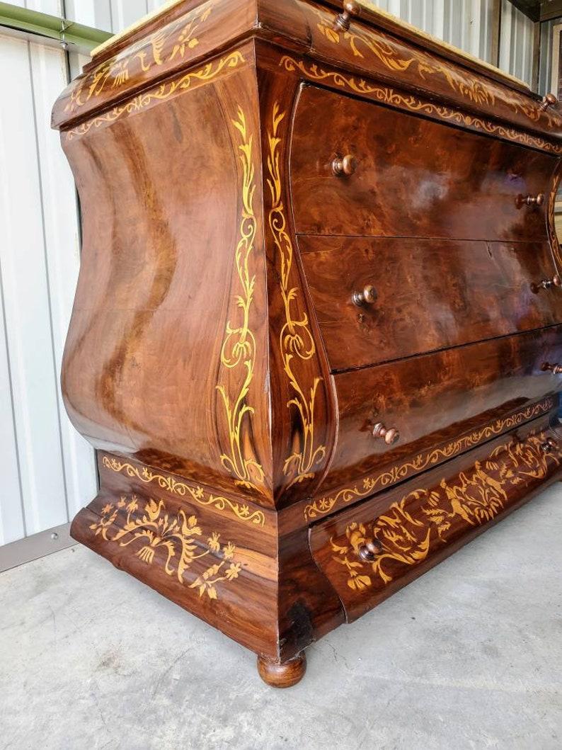 An impressive antique Dutch marquetry chest of drawers which dates to the 19th century. An amazing work of art! Fine, elegant, and substantial, this impressive Dutch inlaid marble-top chest is exquisitely adorned with a plethora of intricate