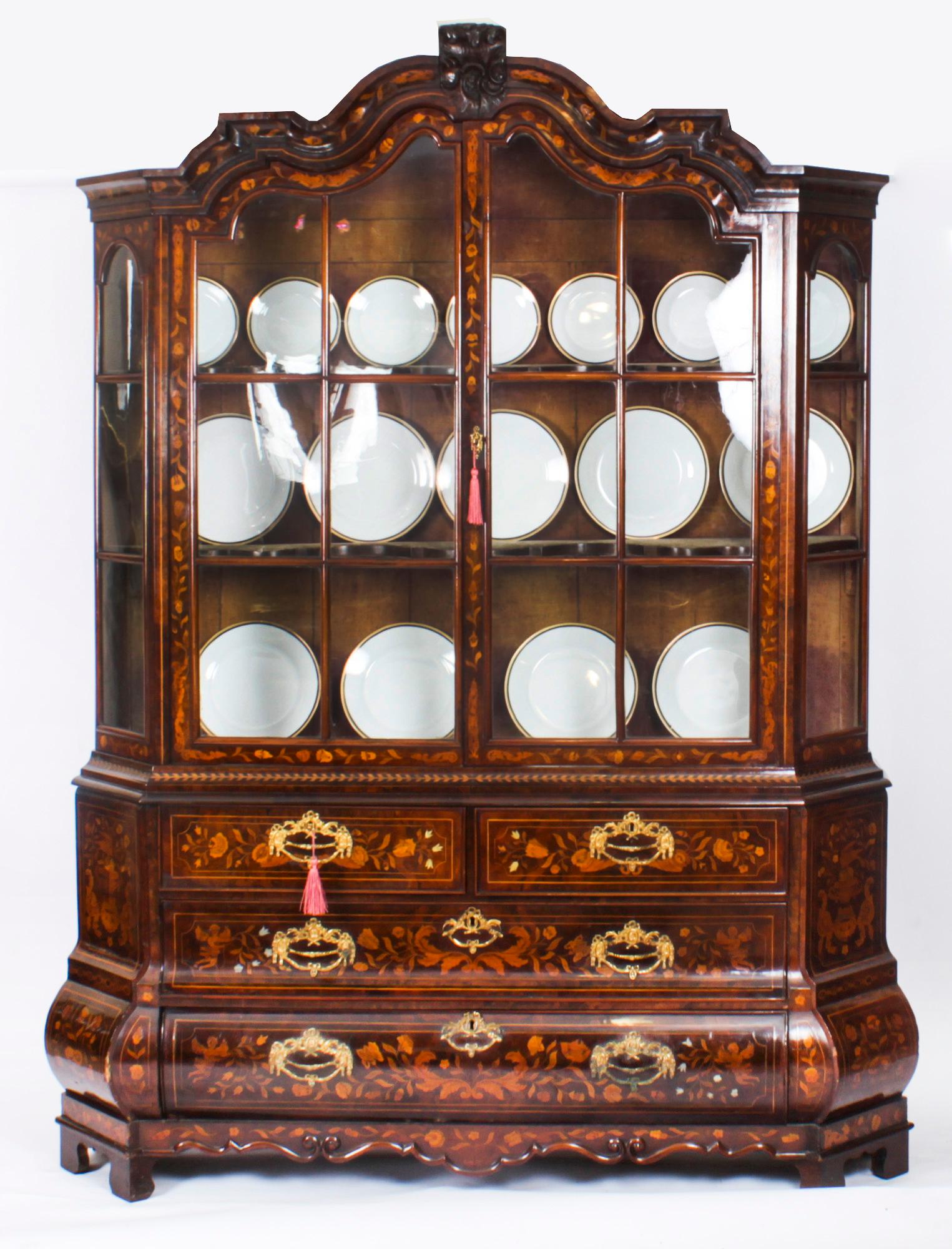 This is a beautiful antique late 18th Century Dutch walnut and marquetry inlaid display cabinet dating from circa 1780.
 
The cabinet is superbly inlaid all over with the most wonderful hand cut marquetry of trailing flowers and foliage.
 
The