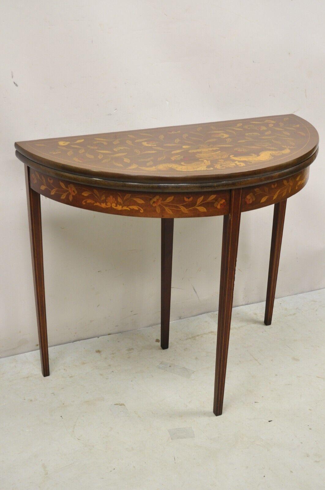 Antique Dutch Marquetry Inlay Flip Top Demilune Console Game Table. Item features stunning floral and figural marquetry inlay, tapered legs, shapely Demilune form, beautiful wood grain, very nice antique item, great style and form. Circa Early to