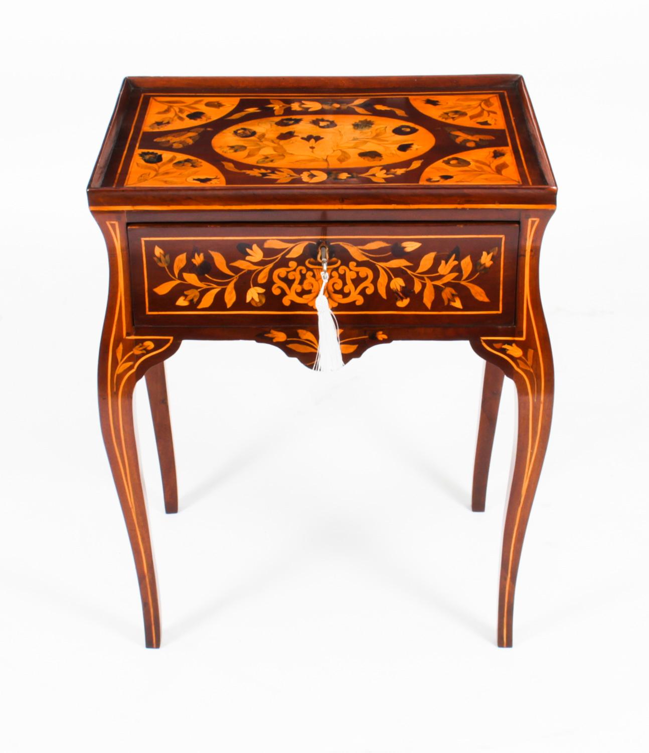 This is a stunning antique early 19th century Dutch floral marquetry tray top bedside cabinet / side table, circa 1820 in date.

This splendid cabinet has been accomplished in striking figured mahogany. The galleried top is decorated with a plethora