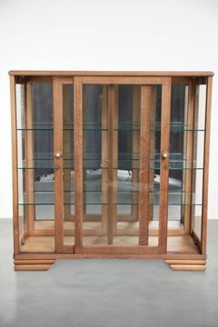 Antique Dutch oak display cabinet with glass shelves and a mirrored back