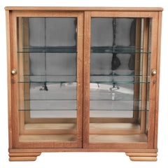Antique Dutch oak display cabinet with glass shelves and a mirrored back