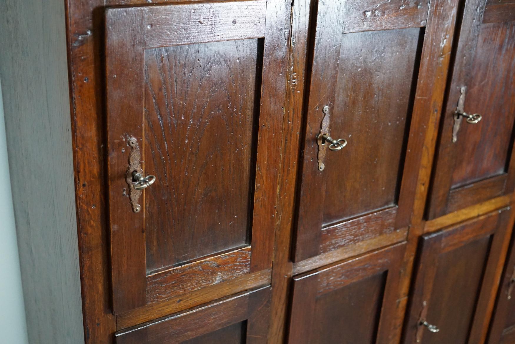 This Dutch oak locker with 16 doors was made around the 1920s in the Netherlands. It was used in a post office in the city of Nuenen. The interior dimensions of the compartments are: D W H 30 x 25 x 38 cm.