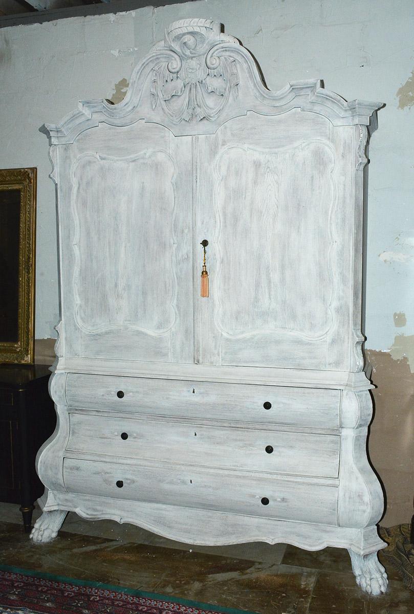 Stately and impressive white washed 18th century Dutch linen press cupboard perfect as dining room china cupboard, entertainment center, bar or armoire. Linen press has three deep drawers below and a double-door storage space above.