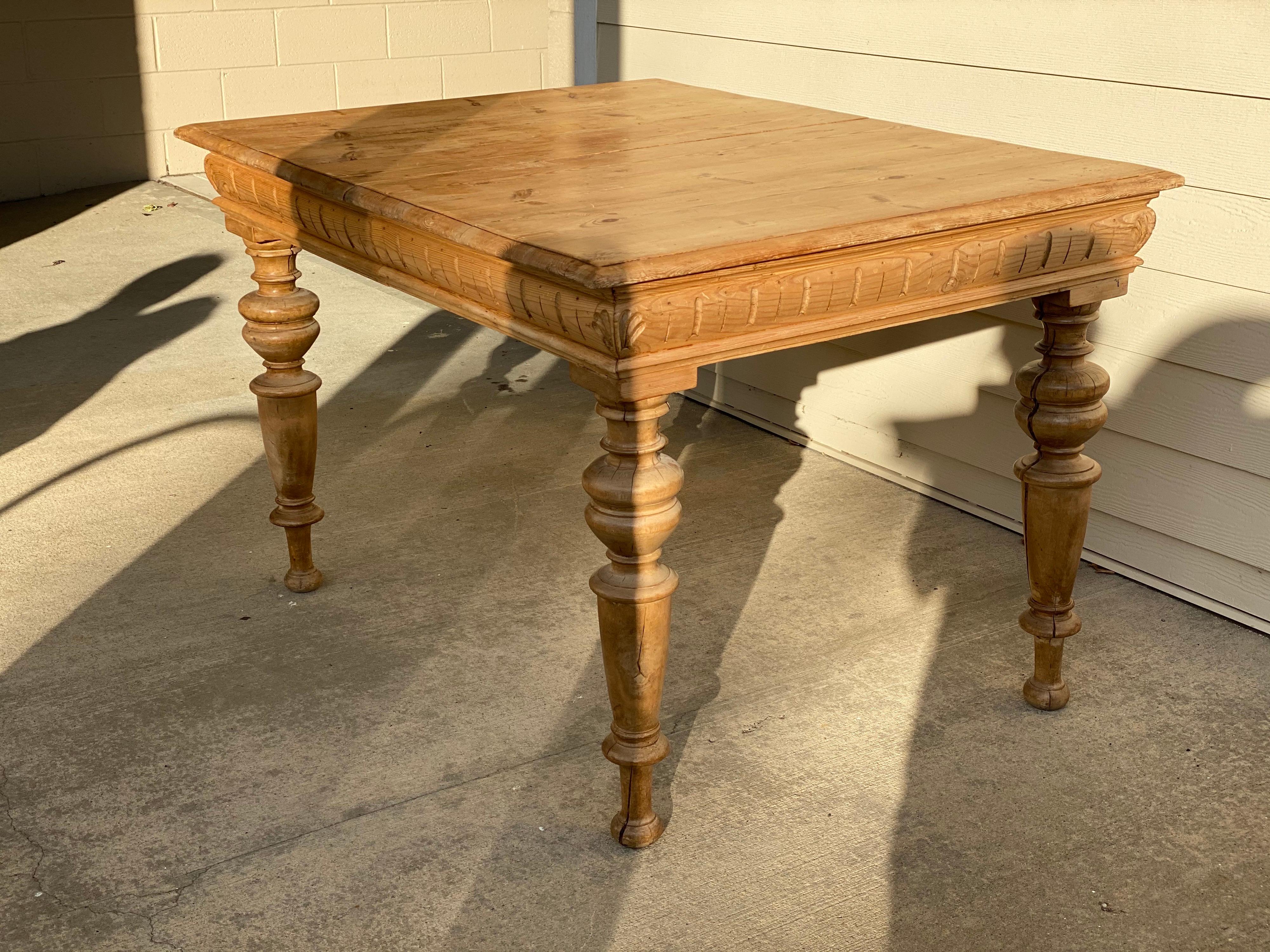 Antique Dutch pine dining table, circa 1870.
This lovely dining table has simple hand carved details on the rail and bulbous hand turned legs. The table extends to allow two leaves for a total extension of 75.25