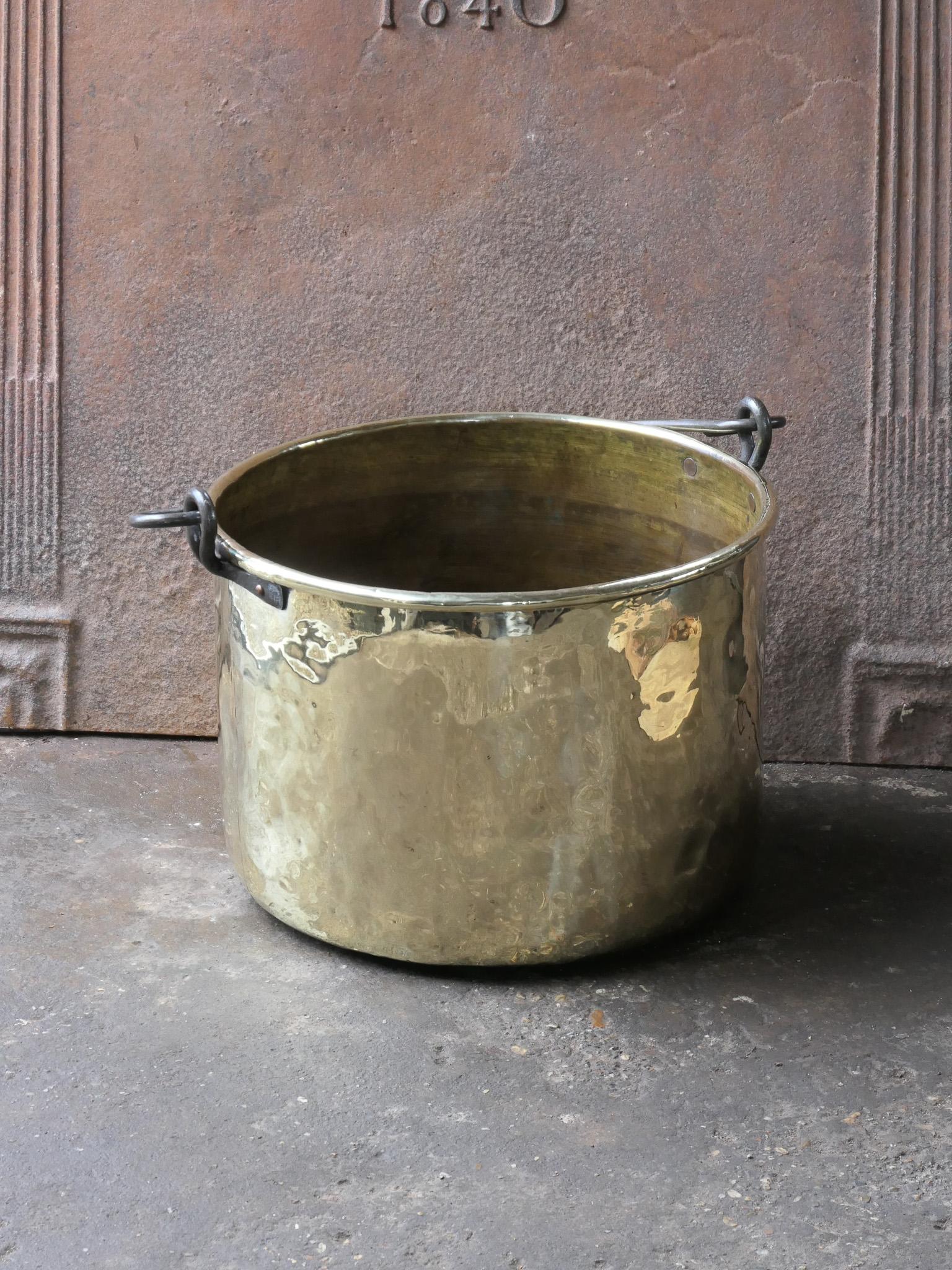 18th Century Dutch log basket. The firewood basket is made of polished copper and brass and has a wrought iron handle. Also called 'aker'. Used to draw water from the well and cook over an open fire.

The log holder is in a good condition and is