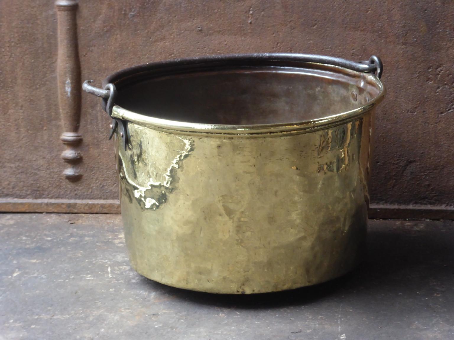 18th century Dutch Louis XV log basket. The firewood basket is made of polished brass and has a wrought iron handle. Also called 'aker'. Used to draw water from the well and cook over an open fire.

The log holder is in a good condition and is