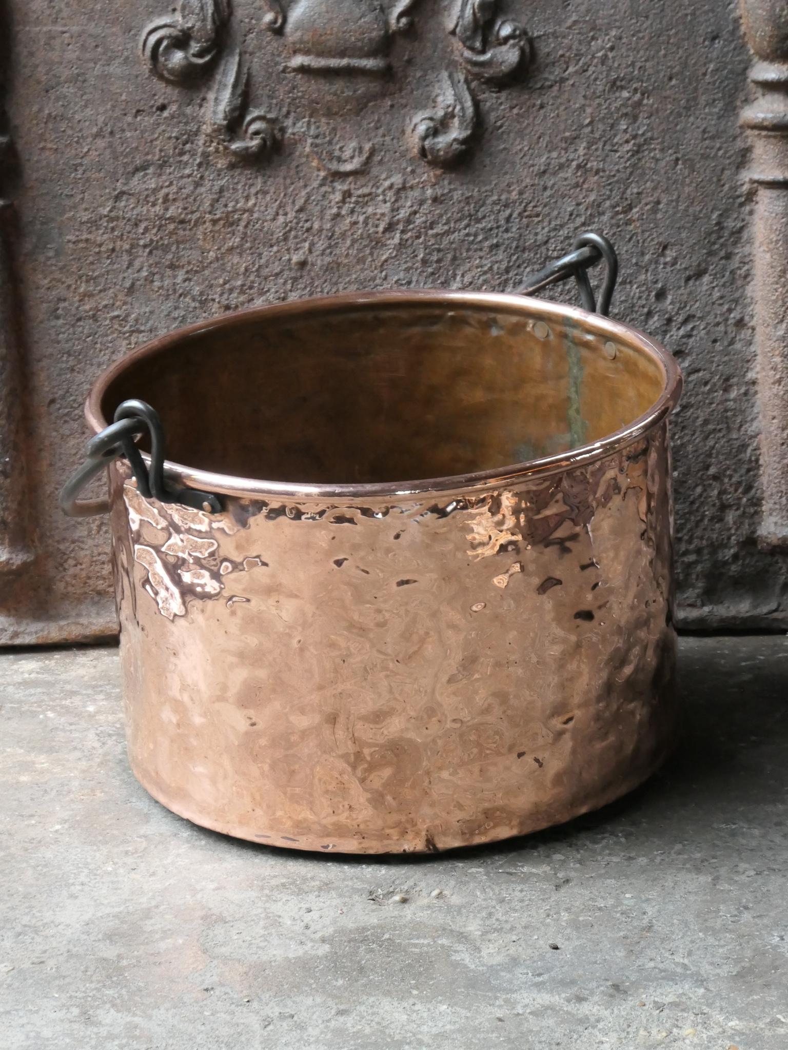 18th - 19th Century Dutch neoclassical log basket. The firewood basket is made of polished copper and has a wrought iron handle. Also called 'aker'. Used to draw water from the well and cook over an open fire.

The log holder is in a good