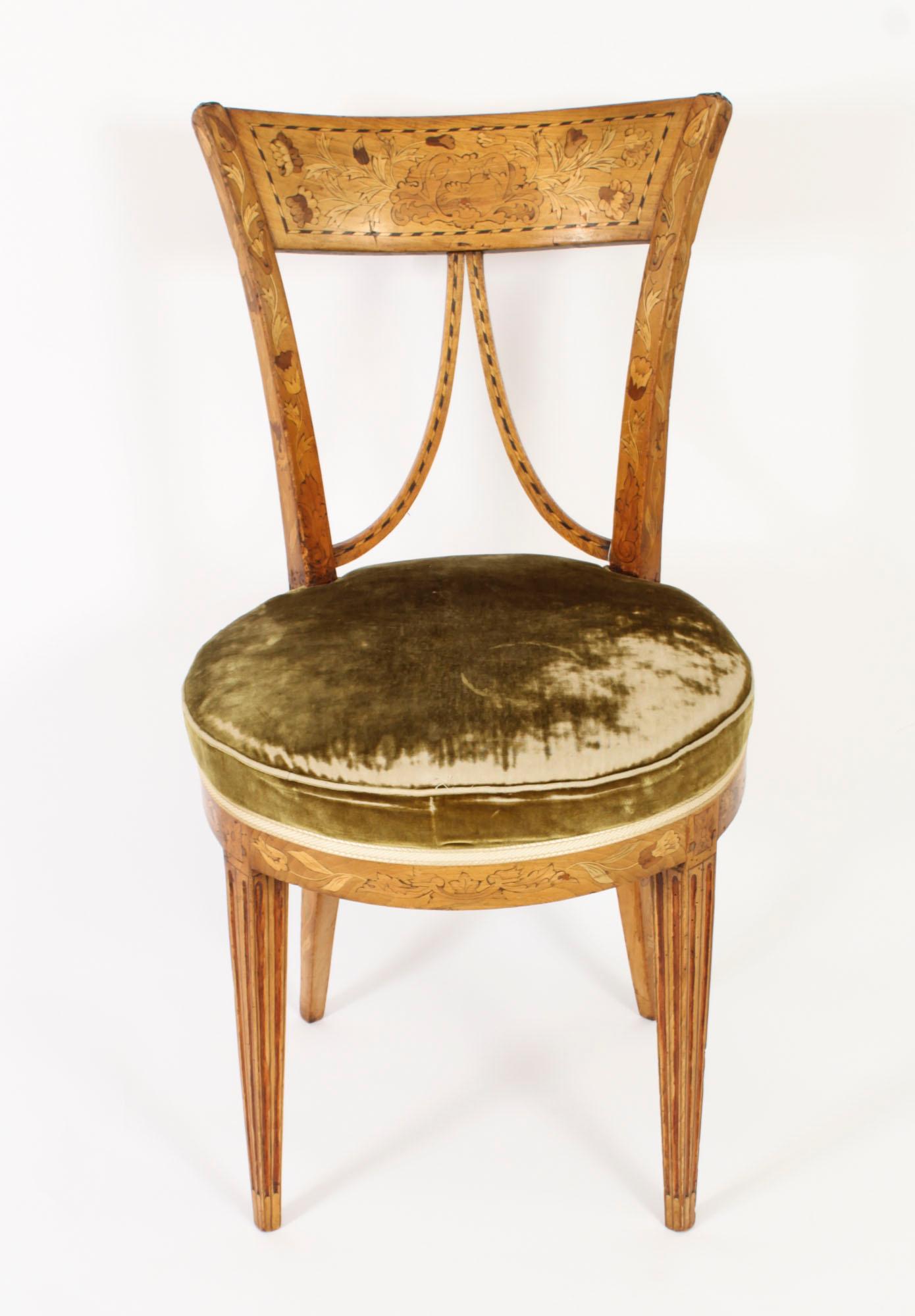 This is a lovely antique Dutch V back satinwood and marquetry chair, circa 1830 in date.

The stunning chair features  sumptuous floral marquetry with ebonised line inlaid decoration.

The over stuffed seat has been upholstered in a green fabric.

