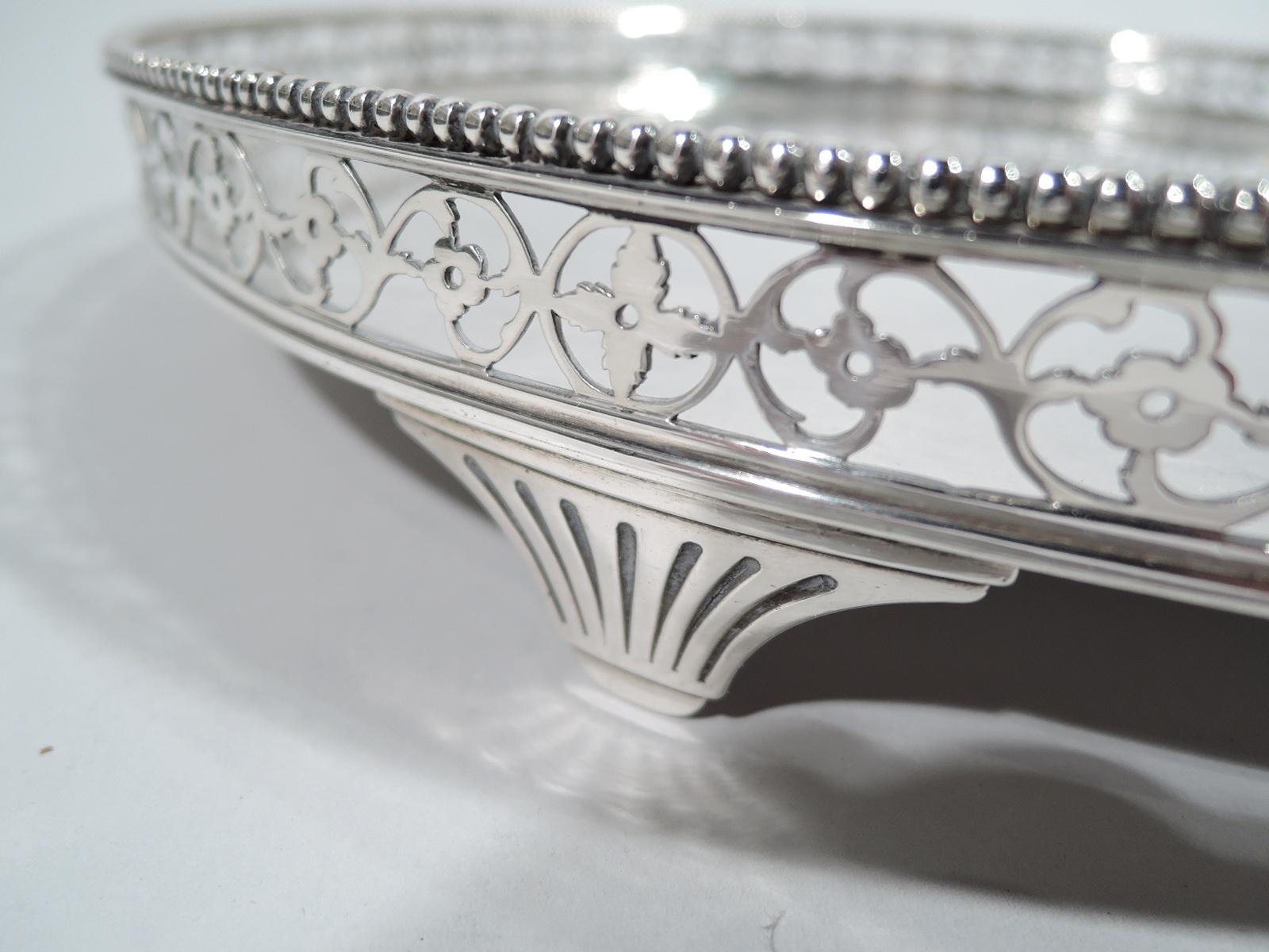 Dutch Neoclassical 934 silver salver, late 18 c. Round. Open gallery sides with flowering rinceaux and beaded rim. Four fluted and tapering supports. Fully marked including Amsterdam city stamp. Weight: 31 troy ounces.