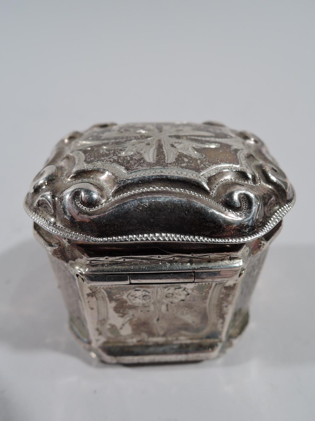 Dutch 833 silver peppermint box, 1879. Rectangular with chamfered corners, and hinged and domed cover. Engraved leaves and flowers alternating with diaper. Cover top has flower bordered by chased scrollwork. Marks include date letter and Minerva