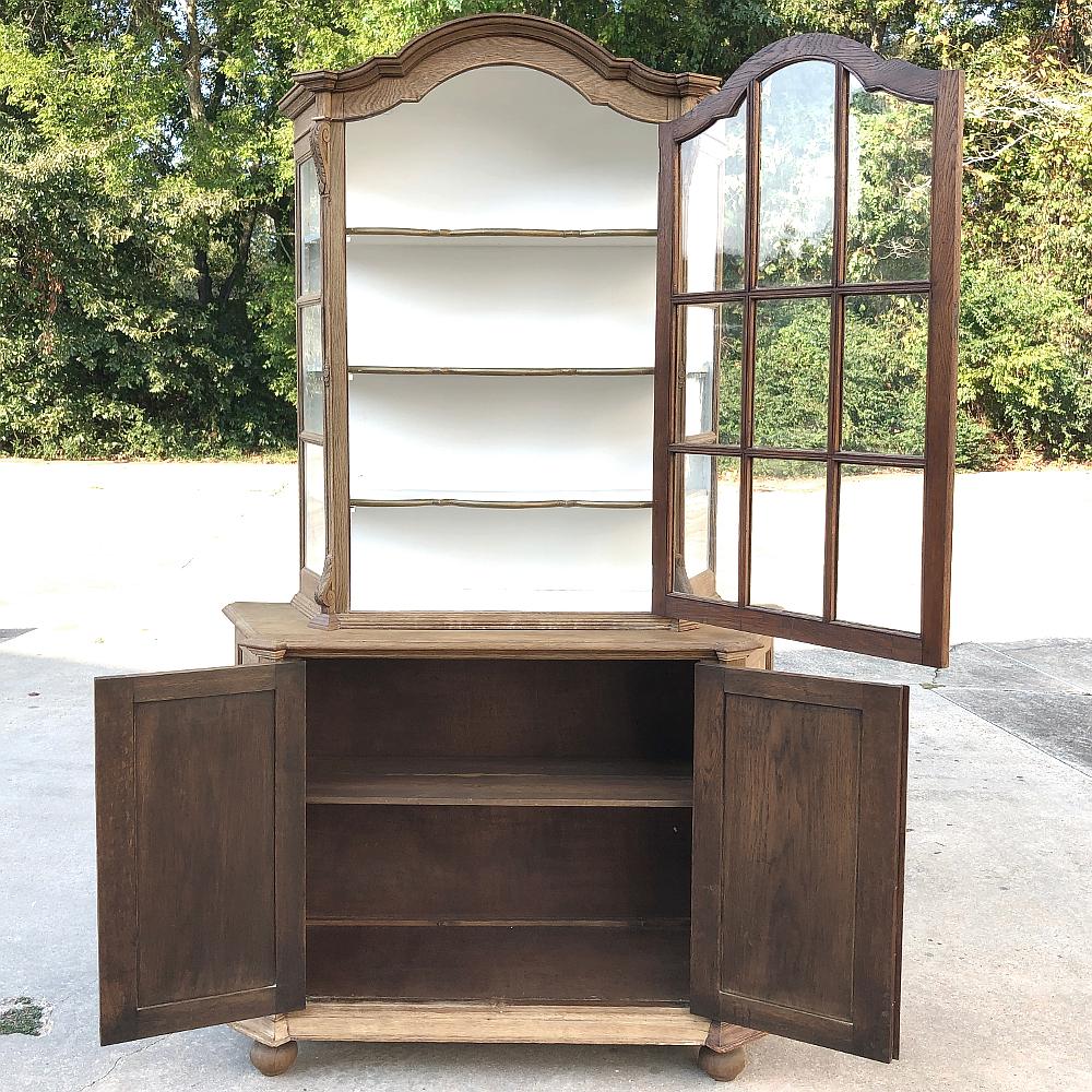 Antique Dutch Stripped Oak Bookcase is the perfect choice for displaying your book collection, or any collection for that matter! Arched crown and fine molded detail abound from the top to the bottom, with a spacious cabinet featuring serpentine