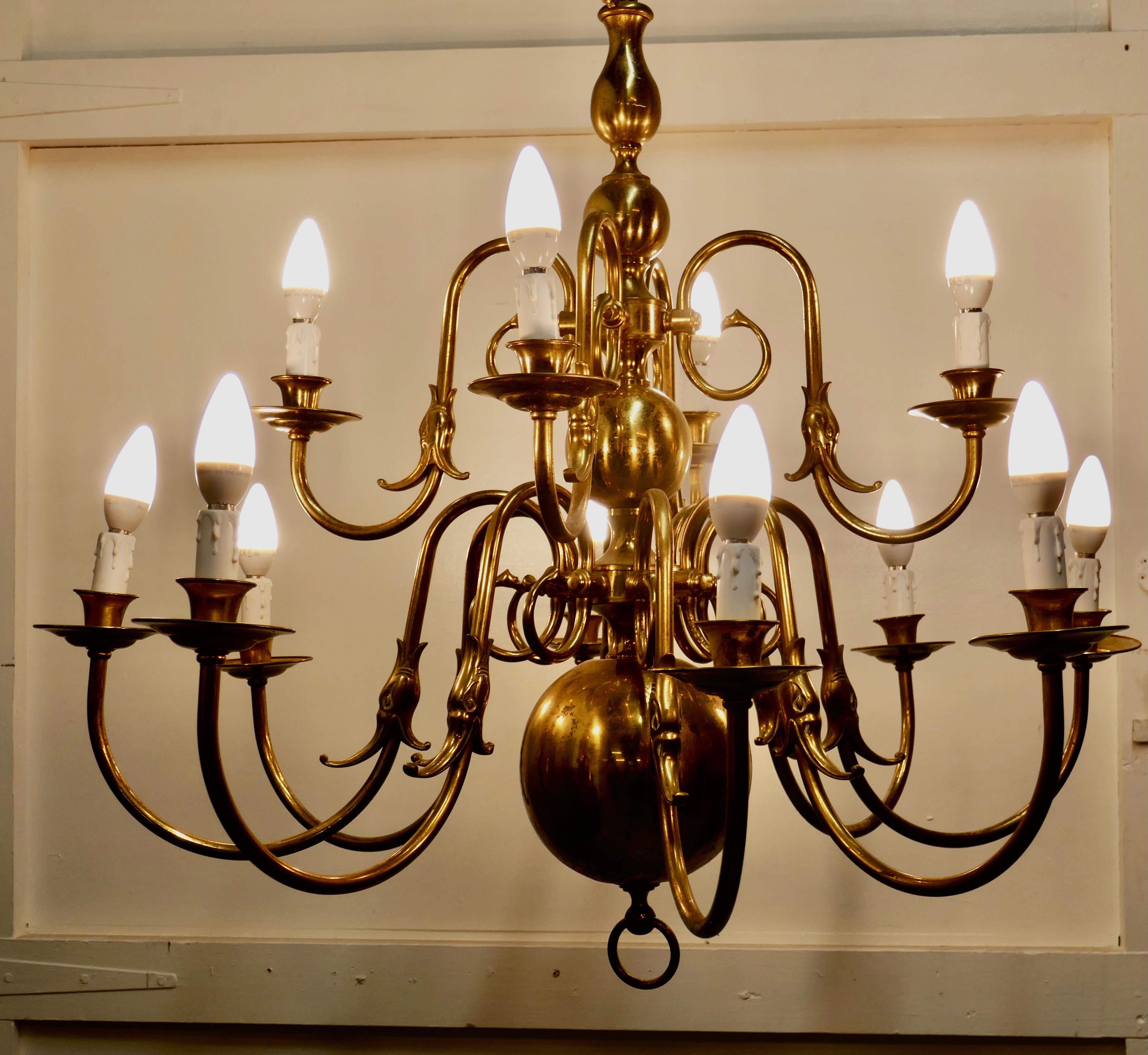 Antique Dutch style twelve branch two tier brass chandelier

This splendid large Dutch style chandelier is made in Brass with twelve upward curved stemming from a central baluster column with a large central globe. At the top of the baluster there