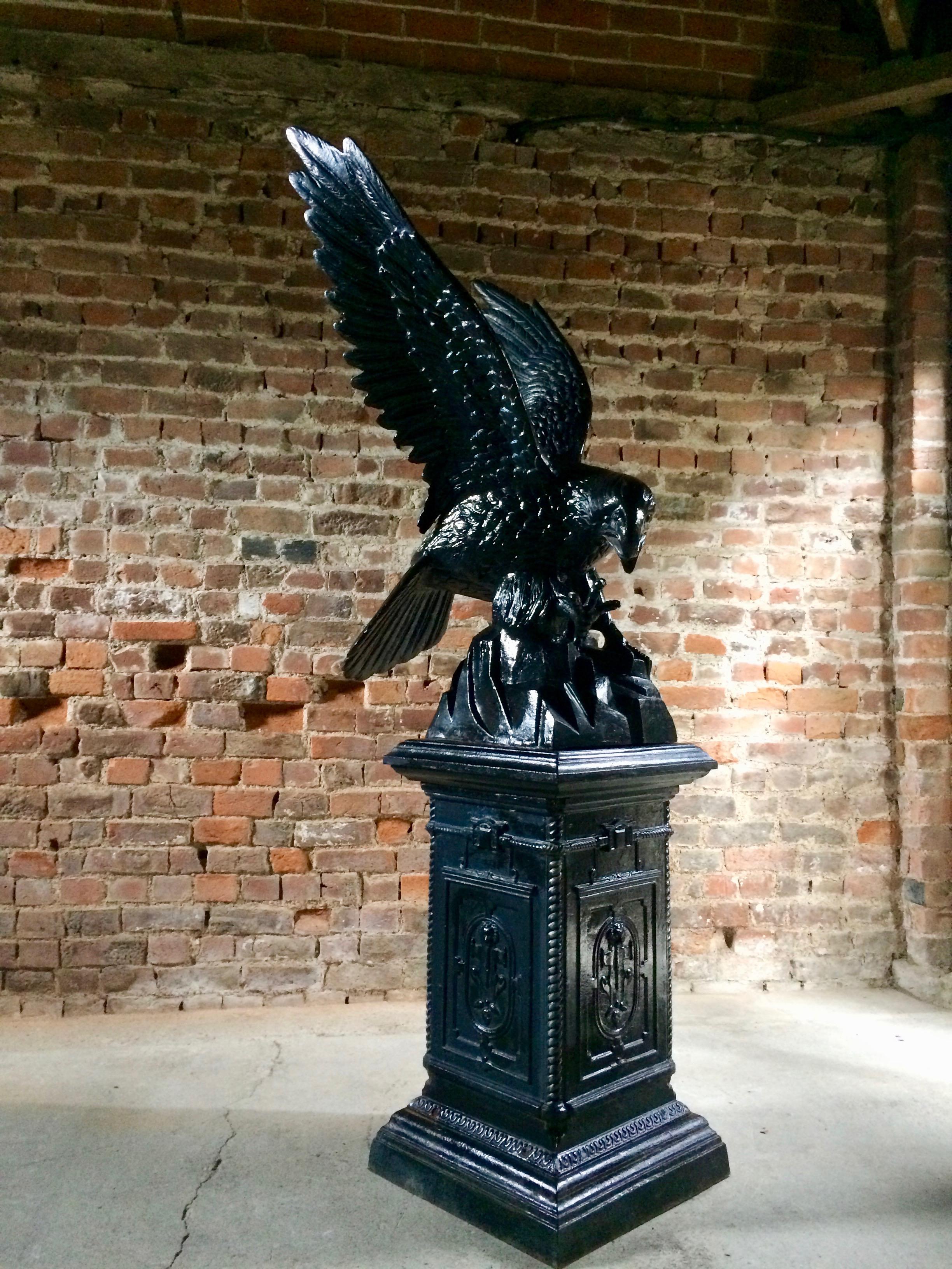 Fabulous large antique cast iron eagle on pedestal dating to late 19th century early 20th century, with outstretched wings sitting on a rock and raised on a tall square pedestal, will enhance any garden. courtyard or front of house entrance, please