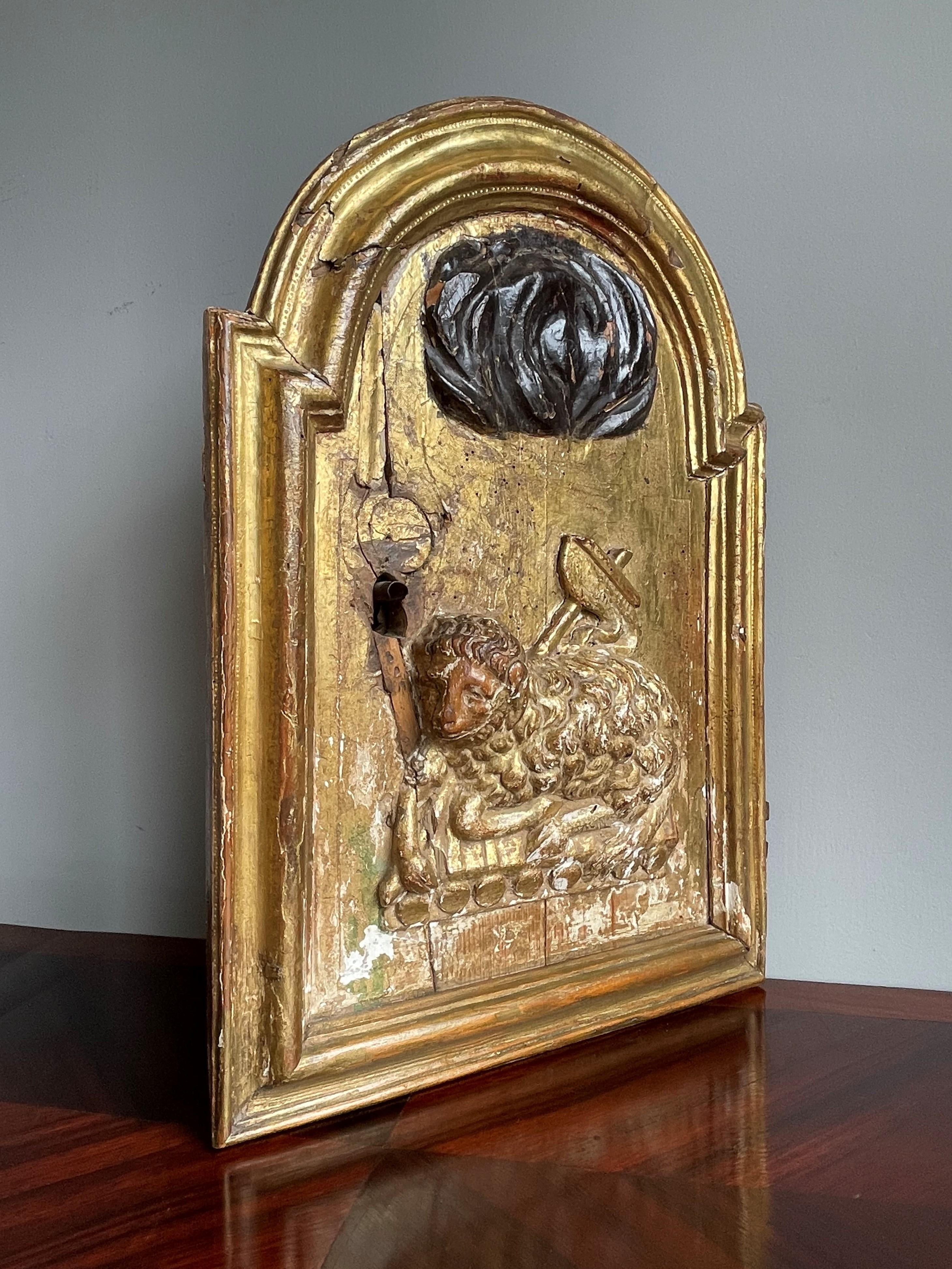 Incredibly old, rare and meaningful, antique giltwood tabernacle door with lamb of god sculpture.

This striking and all handcarved, symbolic tabernacle must have originally been part of a church or monastery tabernacle and it is a real work of