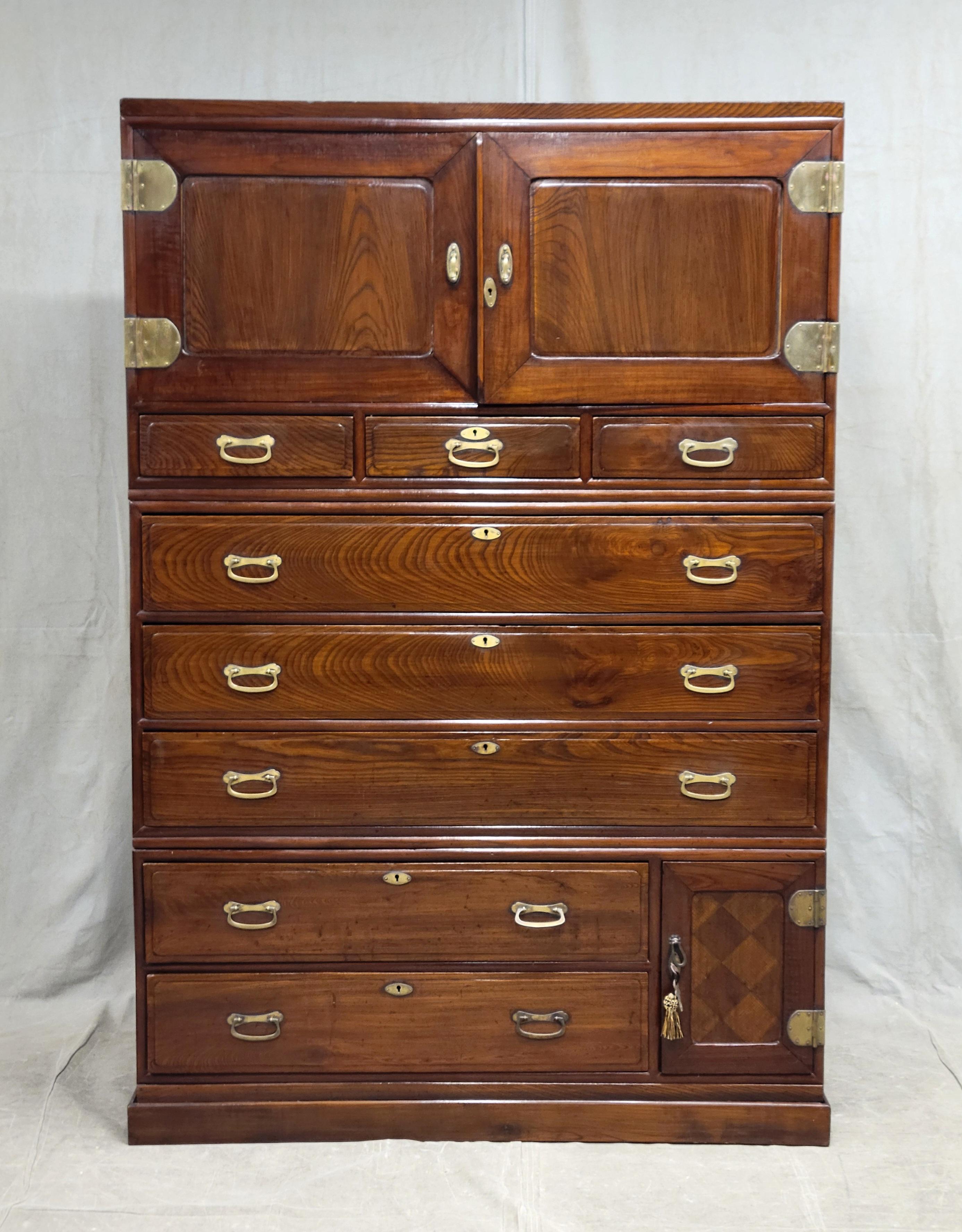 A stunning vintage Korean (in the Japanese style) large elm (keyaki) tansu chest with original cast brass hardware. The hardware and linen chest pine sliding drawers show a European influence indicating that this cabinet may have been created for a