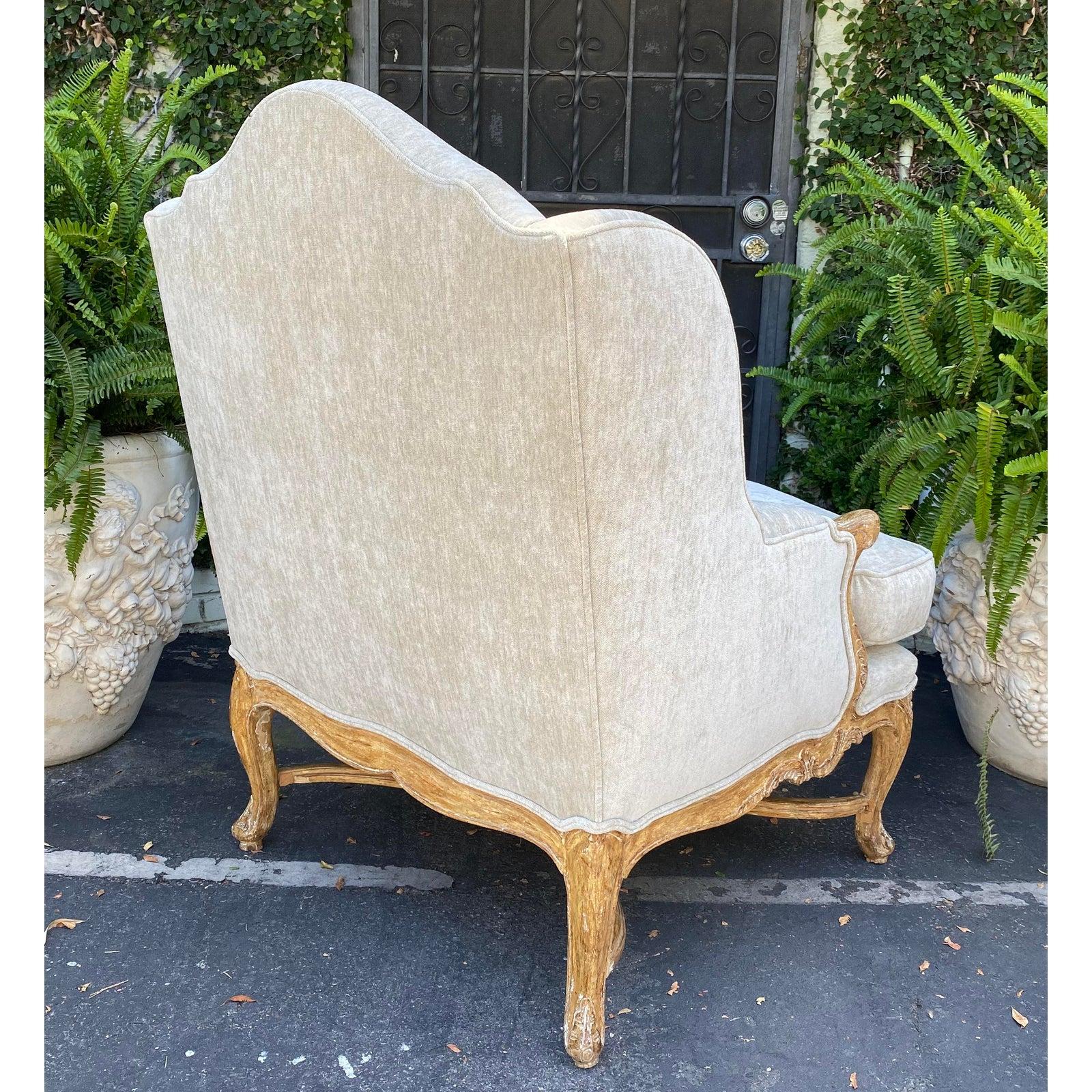 Antique early 19th century carved Louis XV style wingback armchair.