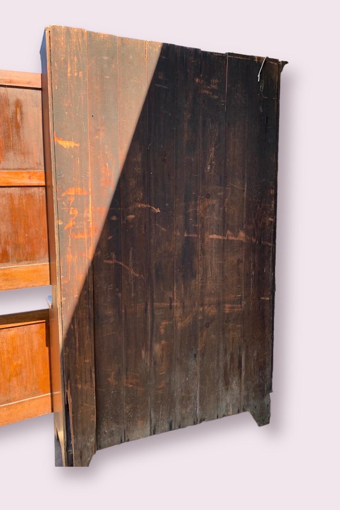 A wonderful two part step back cupboard, the upper case with molded cornice surmounting two paneled doors, opening to reveal four shelves. The upper cabinet is integrated
with the counter/top board of the lower case. Lower case with two additional