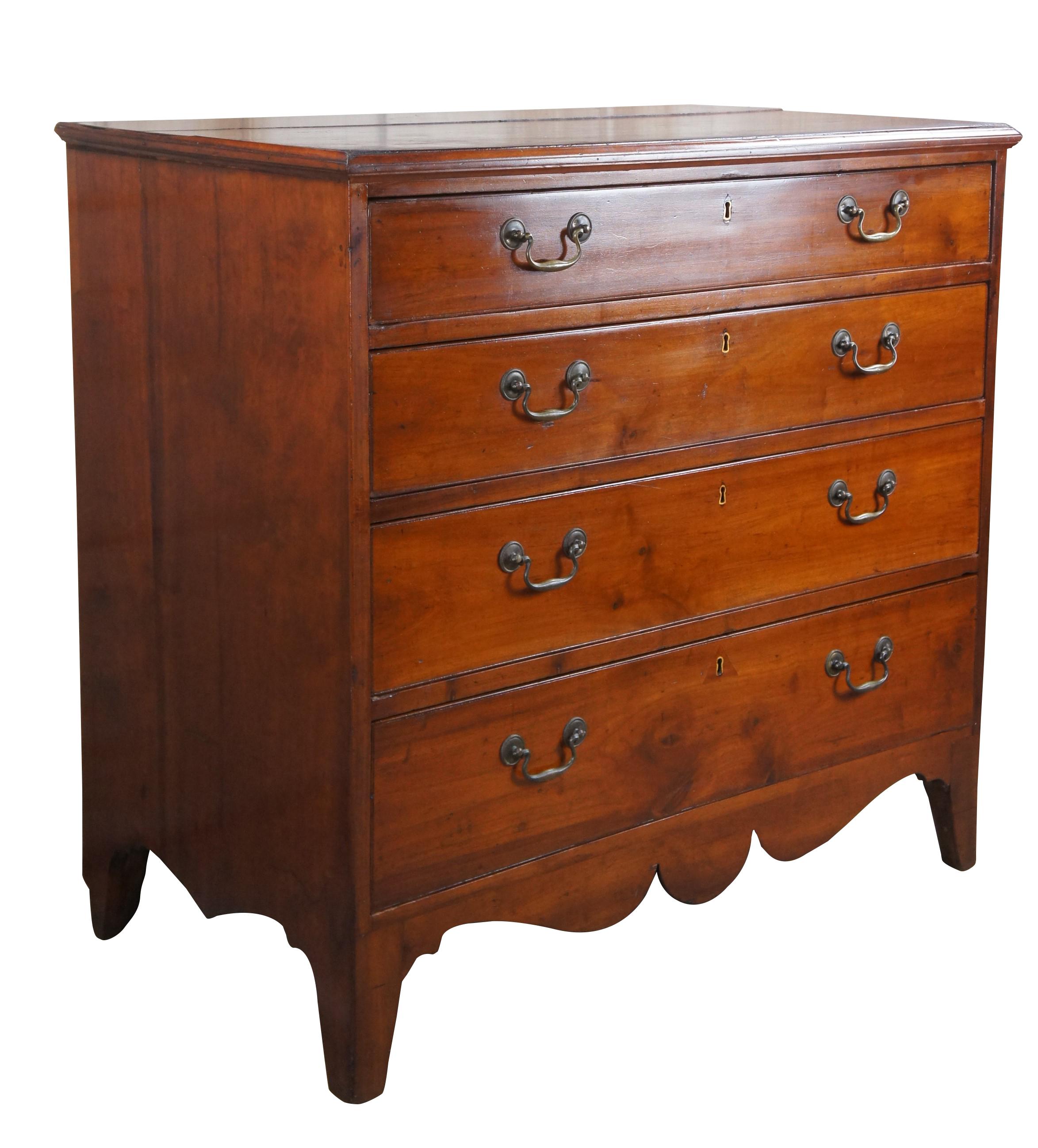 An impressive Federal Period dresser or chest of drawers, circa 1820s.  Made of American cherry featuring four graduated hand dovetailed cock beaded drawers with colonial brass bale pulls and brass escutcheon plates.  The rectangular frame is