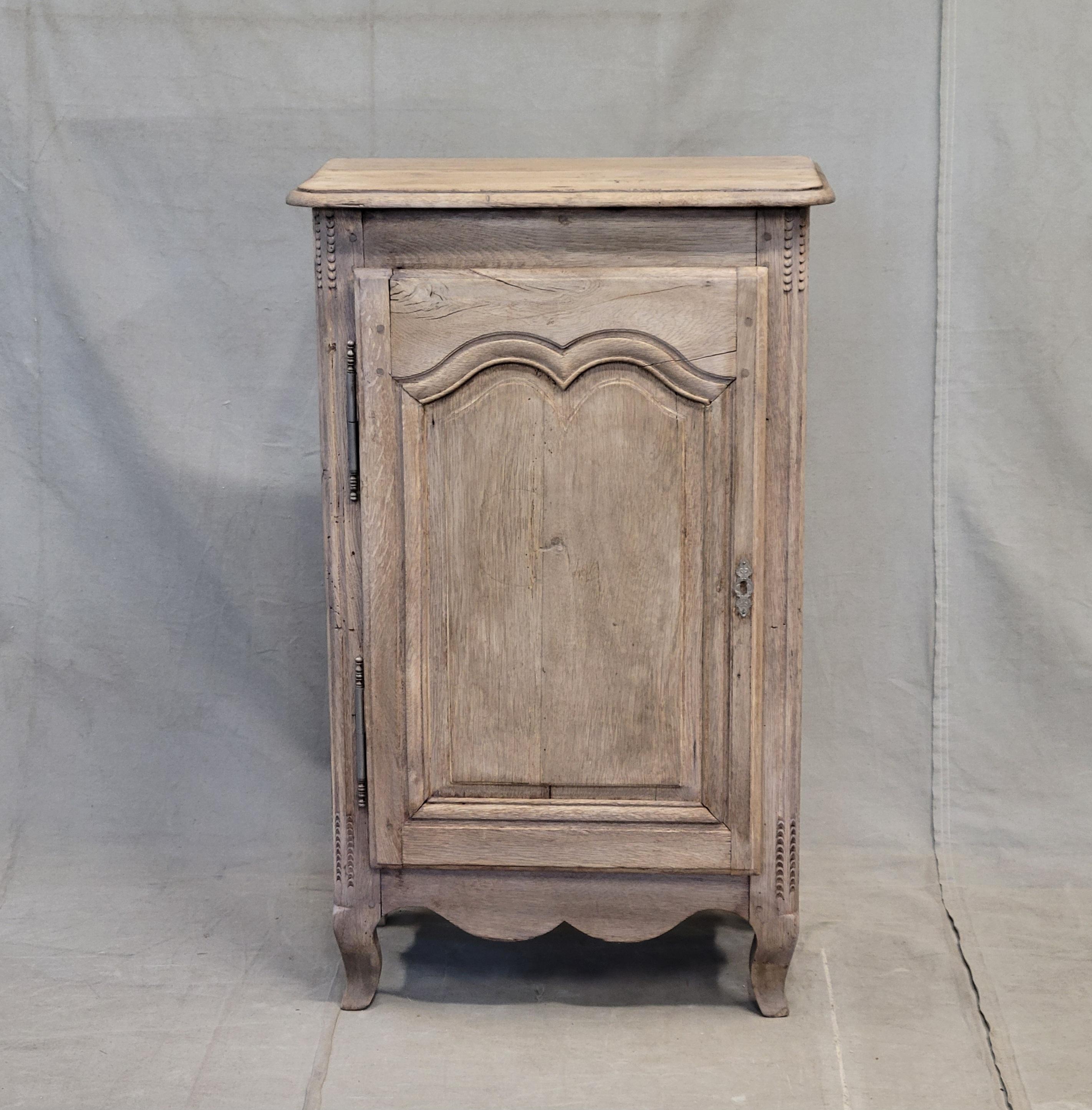 A beautiful antique 19th century French bleached oak cupboard with 2 shelves. This piece could be used as a nightstand or side table. 
Random imperfections and scratches in the wood from age and use. No key but it has a modern magnetic latch to keep