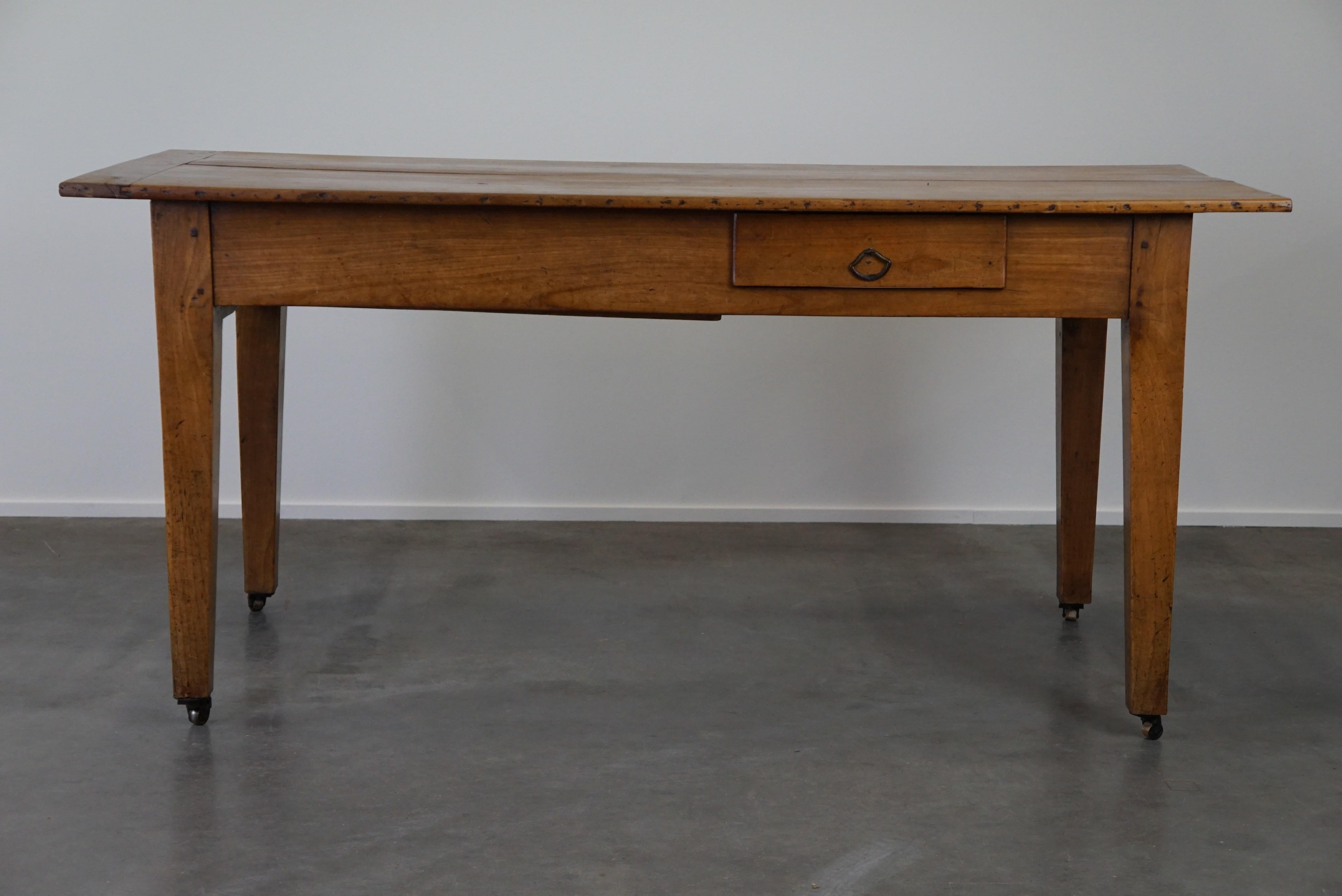 Fruitwood Antique early 19th-century French dining table on casters, made of fruitwood and For Sale