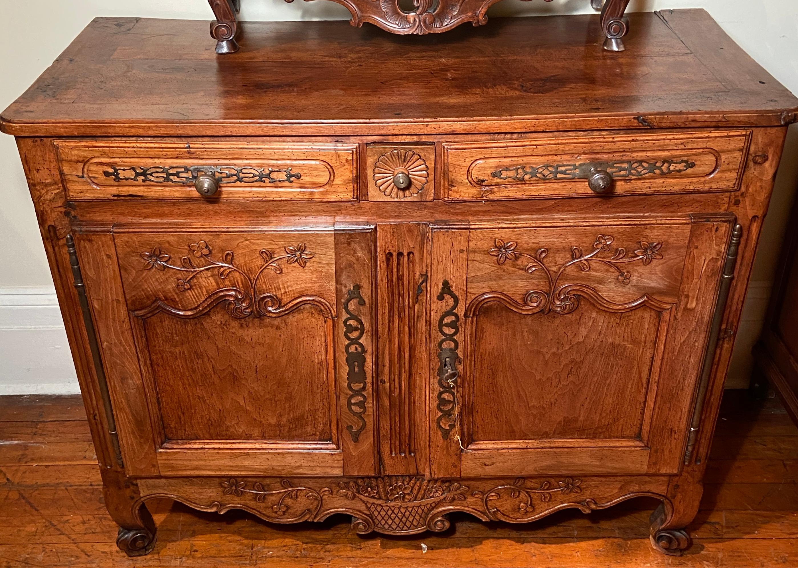 Antique early 19th century French carved fruitwood commode.
Beautiful hardware and carving.