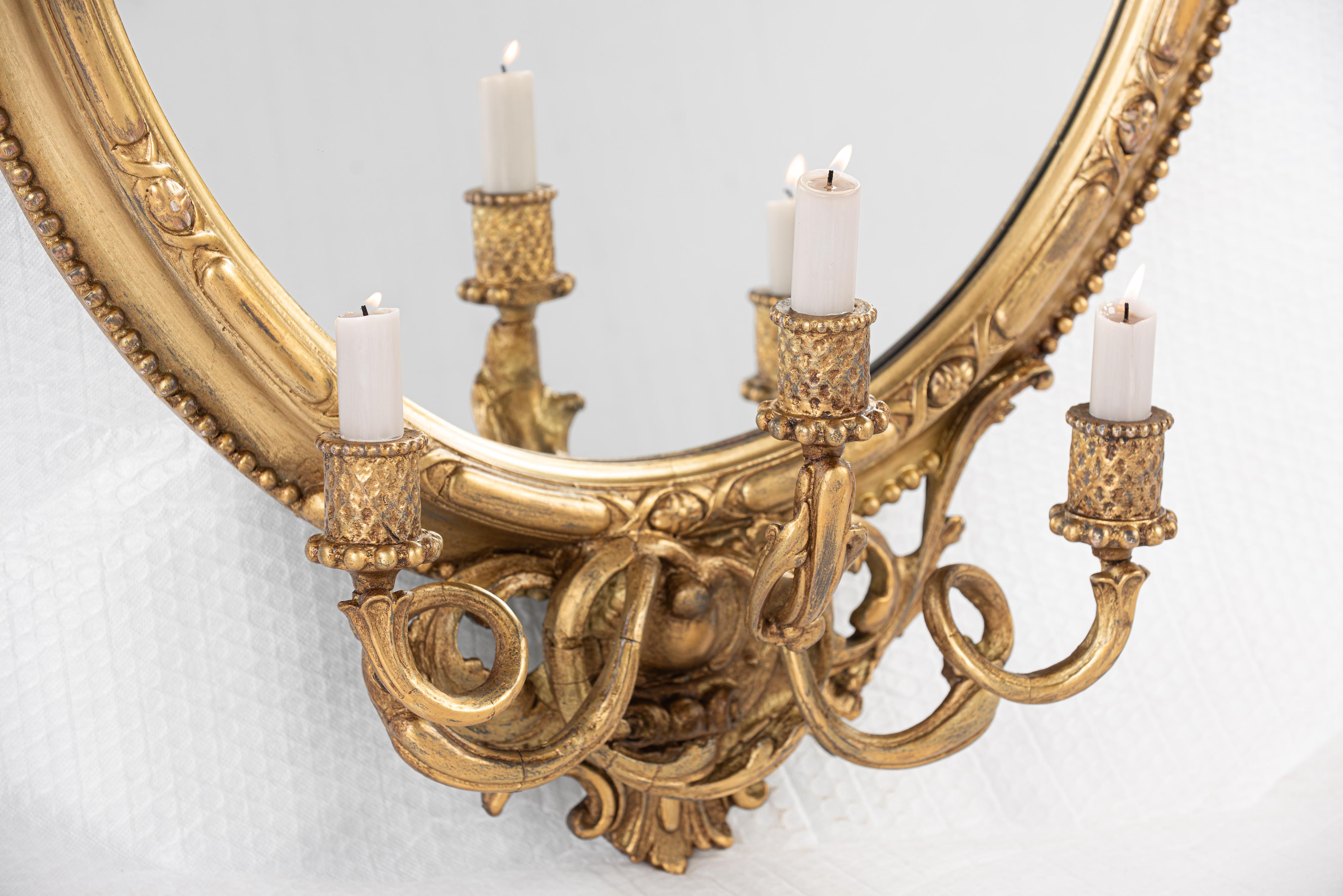 19th Century Antique early 19th century French Rococo gold oval mirror with candle holders