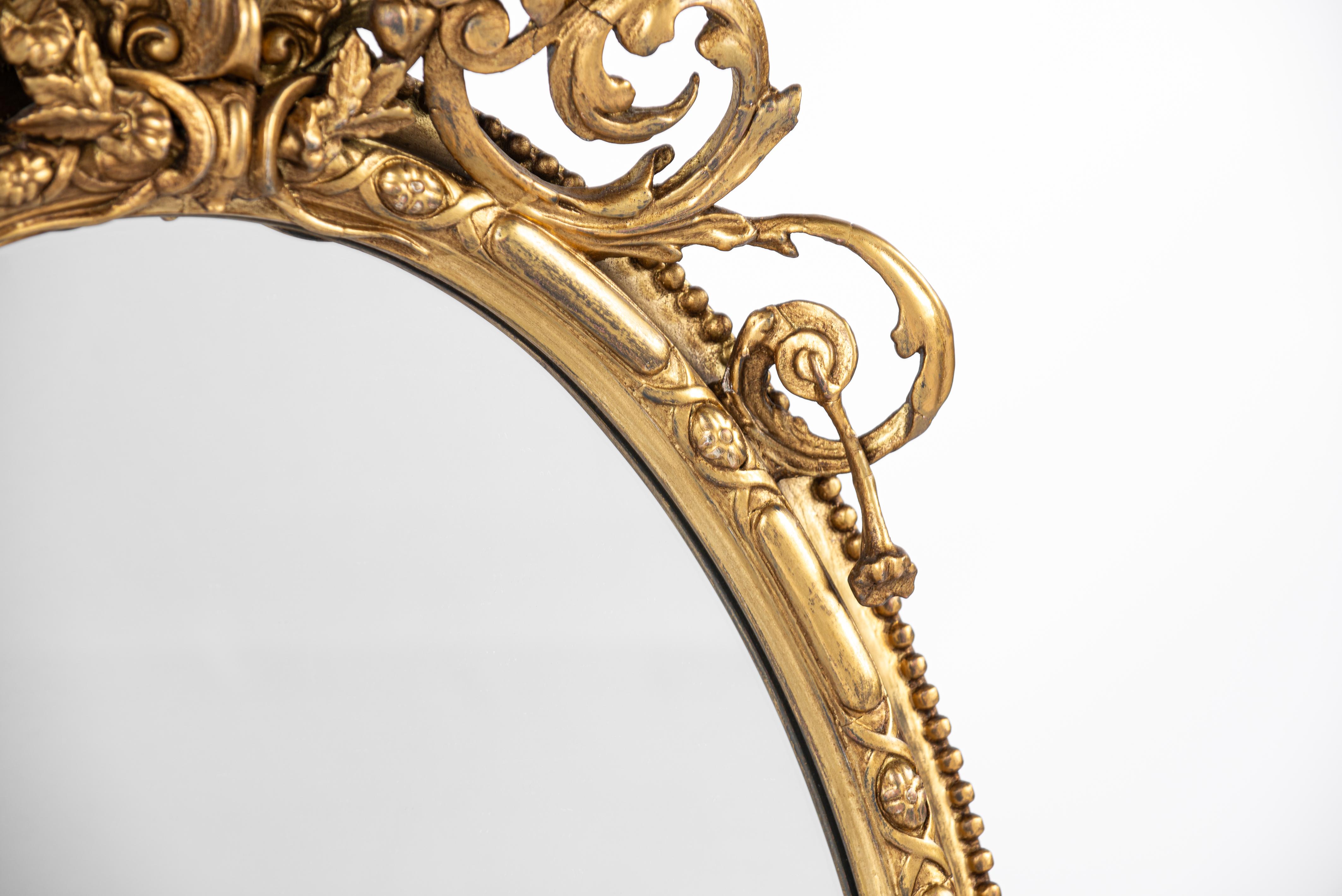 Gesso Antique early 19th century French Rococo gold oval mirror with candle holders