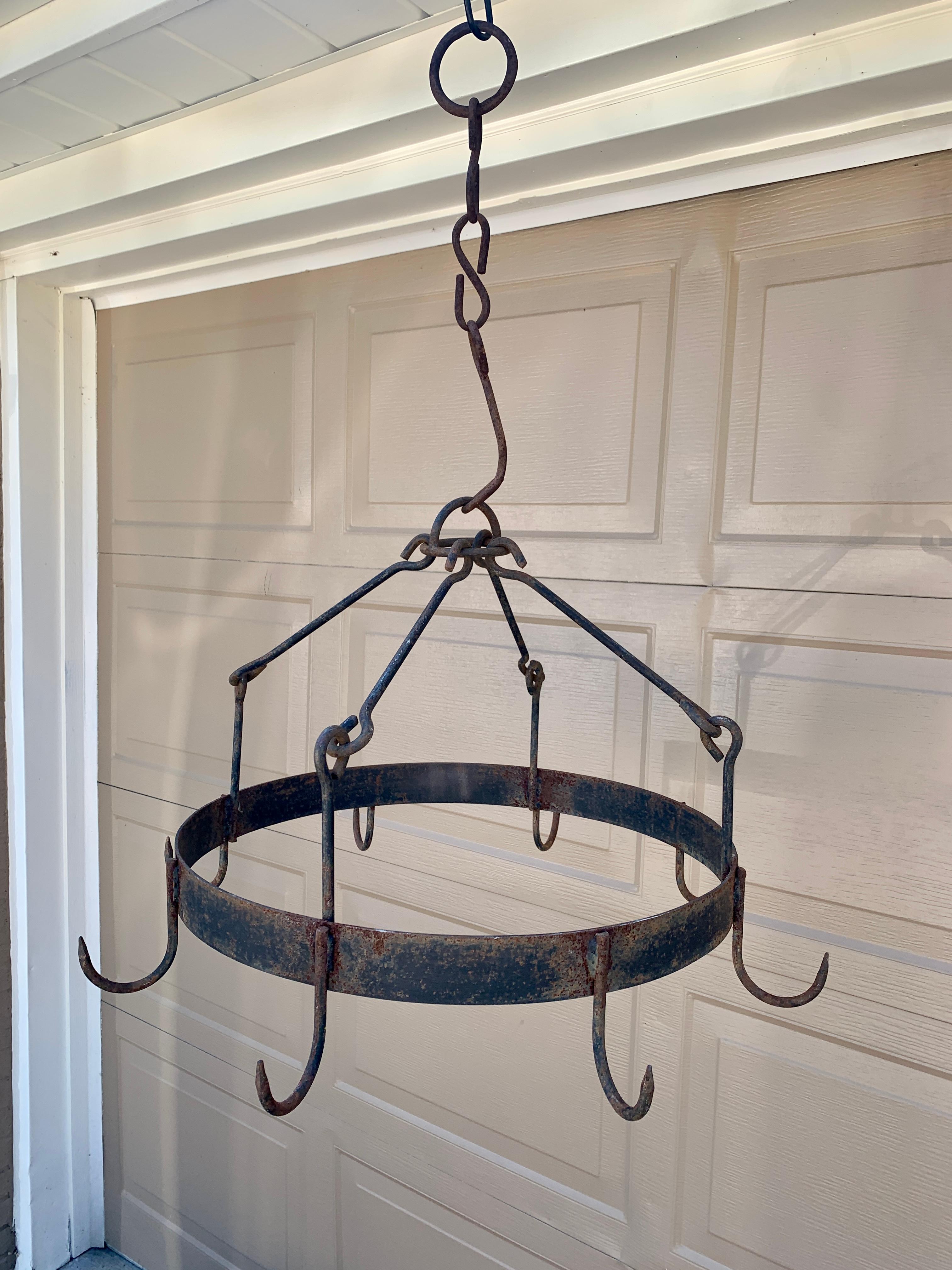 A very nice early 19th century blacksmith handwrought iron game rack with a center ring with eight hooks supported by four arms. Game racks are used to hang small game meat such as fowl, rabbits, etc to dry after a hunt. They were also used to dry