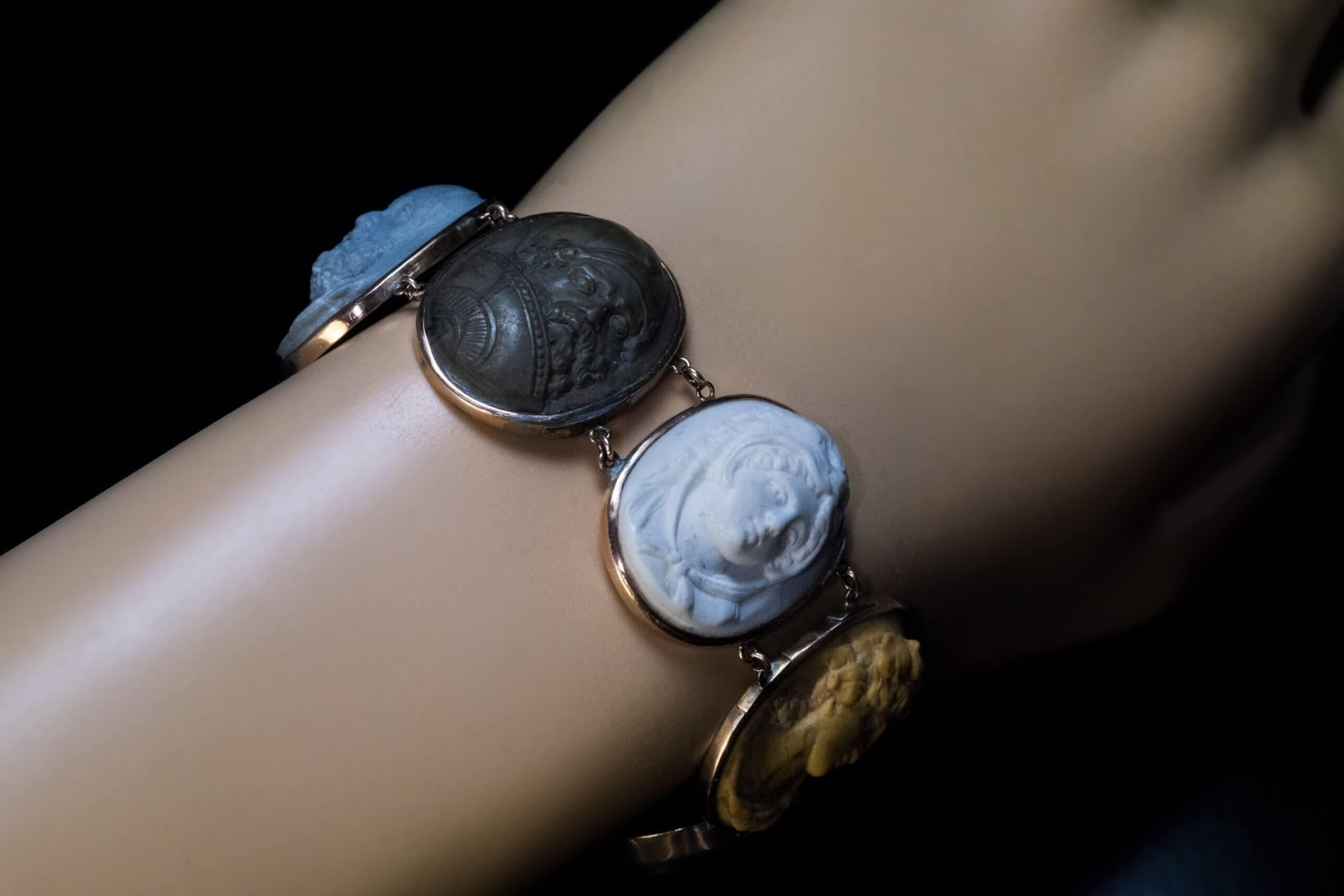 Italian, circa 1820  The rose gold bracelet is bezel-set with seven exquisitely carved in high relief cameos from Mount Vesuvius lavas. The cameos feature deities (Athens, Hercules, Dionysus) and famous philosophers and historical figures of the