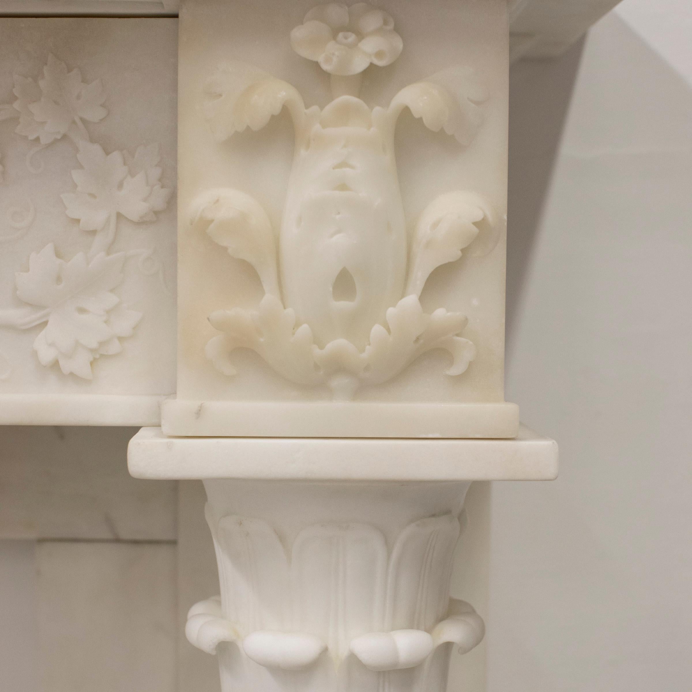 This impressive antique fireplace surround has been expertly carved and crafted from statuary marble.

The ornate fireplace is a true masterpiece, with its intricate carving and delicate details. The beautiful carved vines and grapes that adorn the
