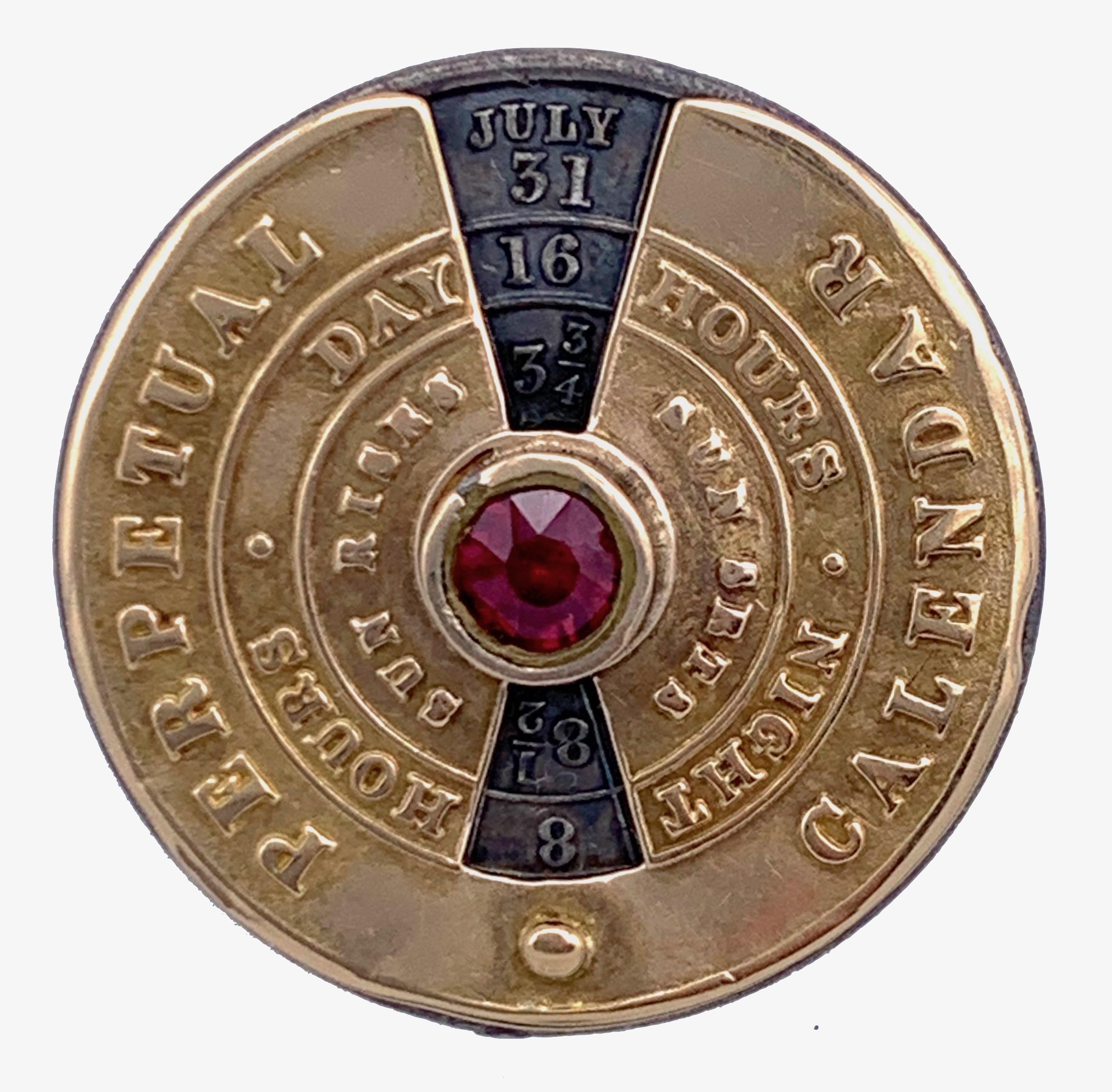 Highly unusual and rare perpetual calendar made out of gold and silver. The outer golden case and the rotating silver disk are held in place by a gold rivet set with a red glass stone. The back of the calendar shows the day of the month and the