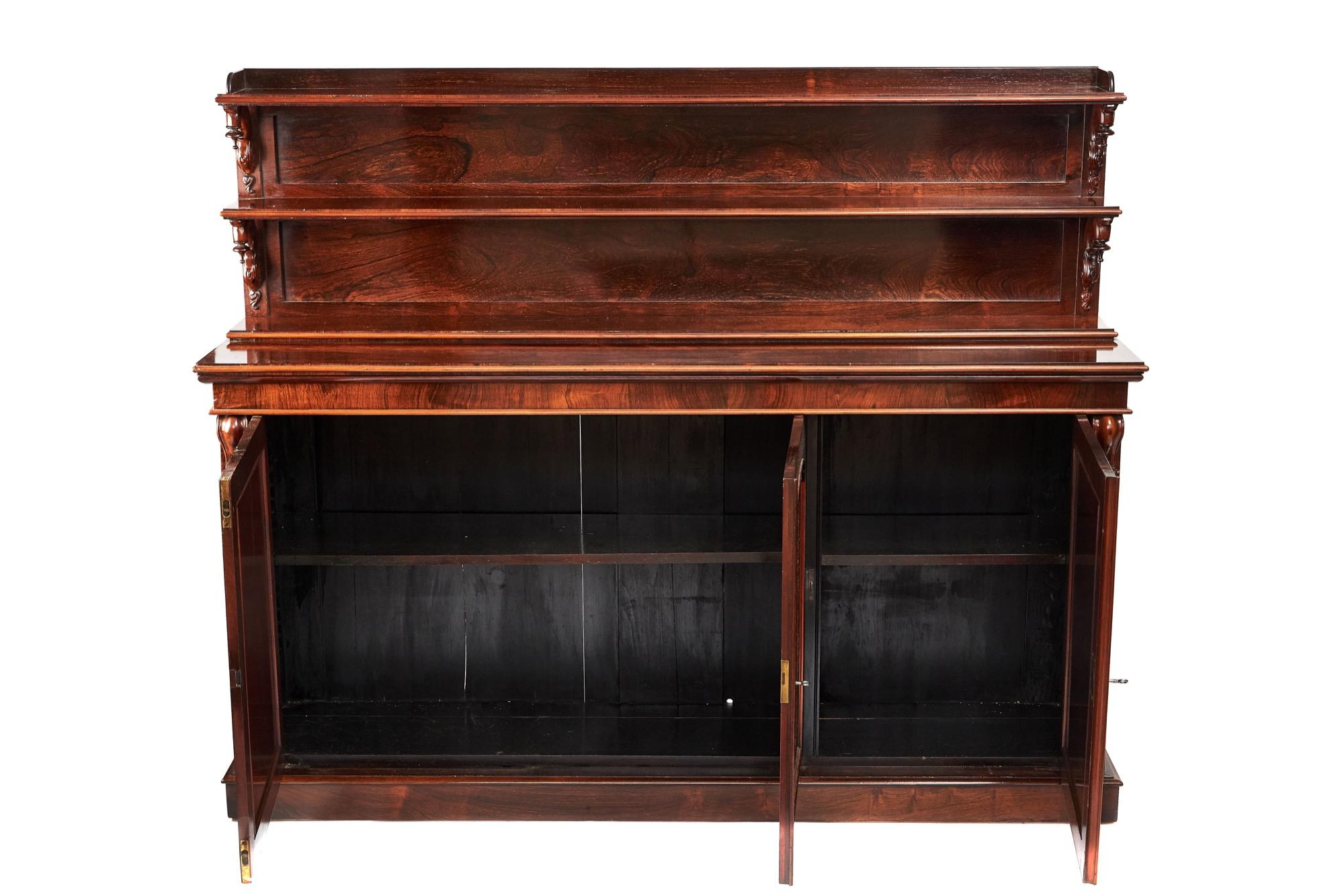 Antique early 19th century Regency Goncalo Alves three-door side cabinet. This is the most magnificent example having a three-tier shelved back with beautifully carved supports, three arched doors to the base flanked by glorious carved corbels