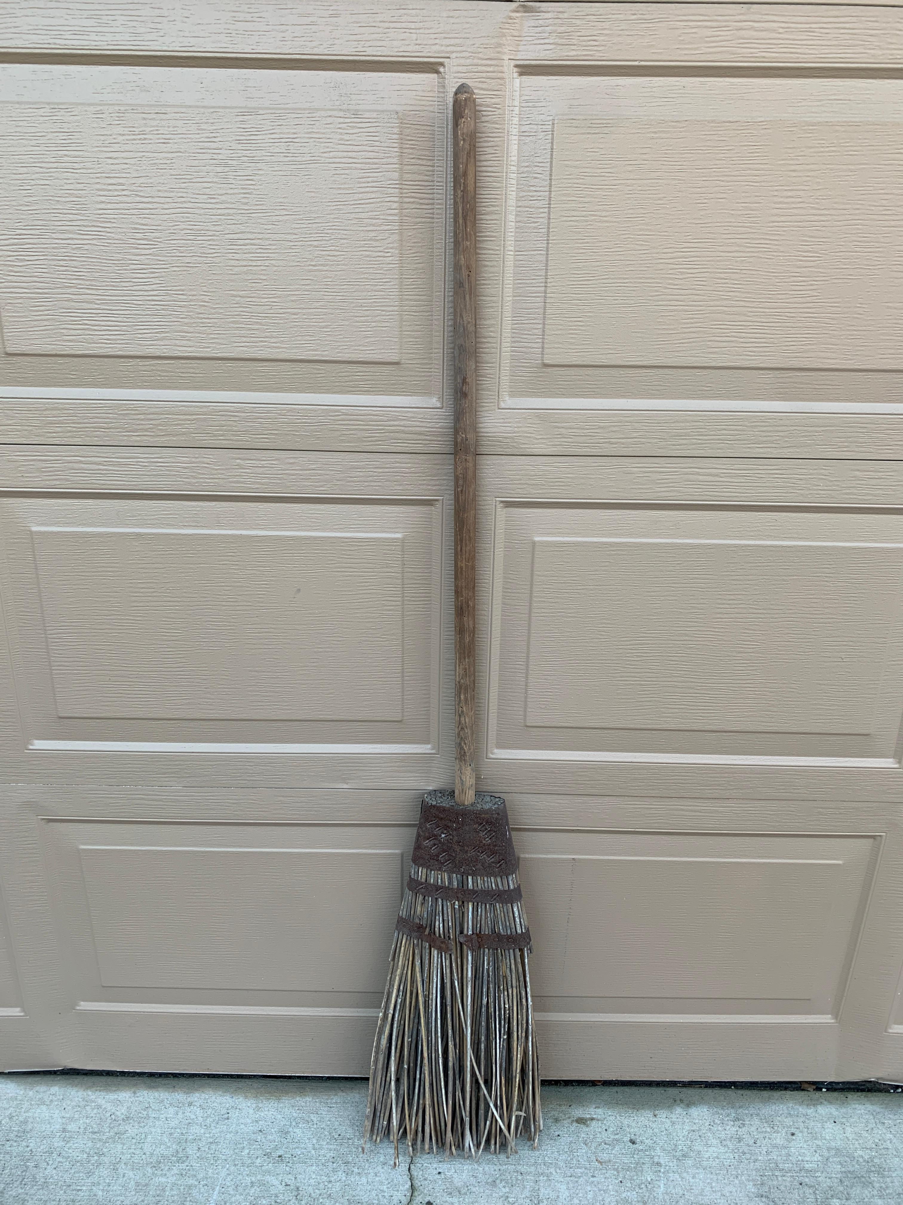 A beautiful and rare antique rustic, farmhouse, or country wooden hand made broom. The broom is made from twigs and would make a gorgeous addition to your country house, Hampton's home, or farmhouse. This would be ideal for an installation on a wall
