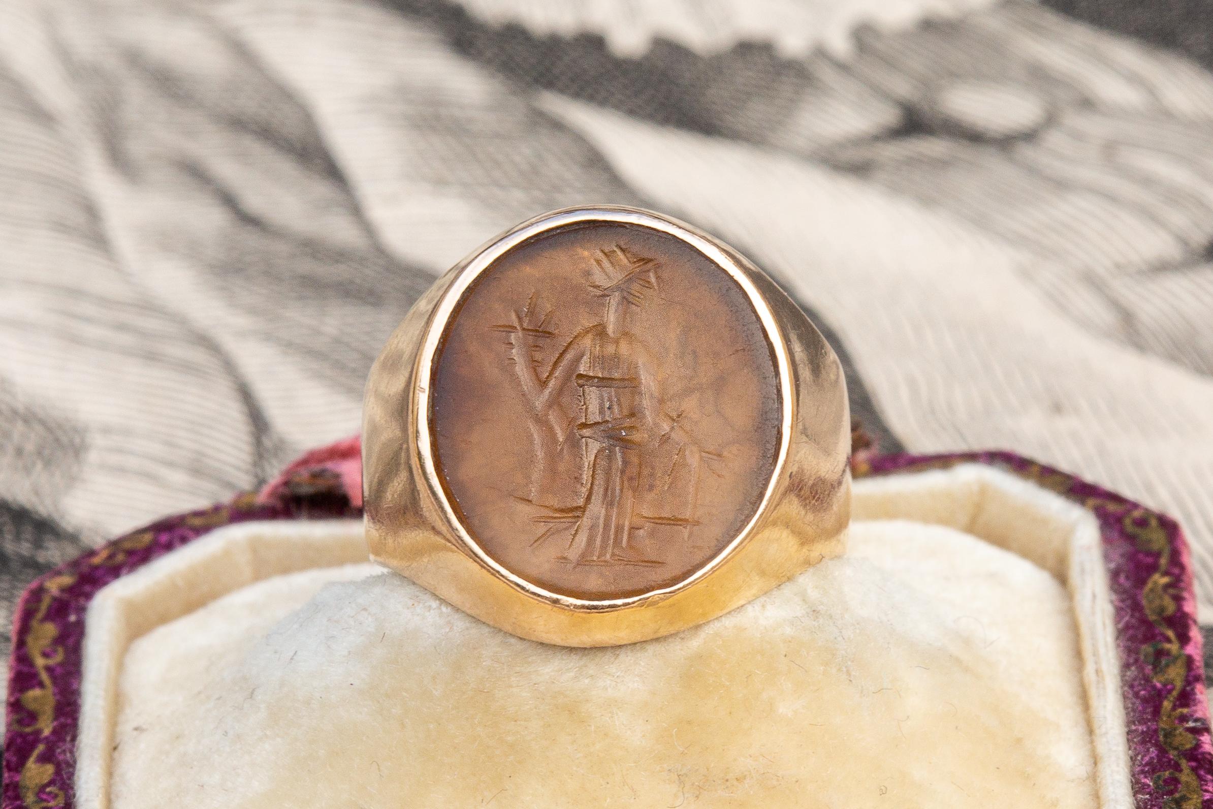 A superb early 19th century (c.1800) French gold signet ring set with an Ancient Roman intaglio. The light-brown agate gemstone is crudely engraved and dates to the 1st-3rd century AD.  It is typical of Romano-British intaglios and depicts Fortuna,