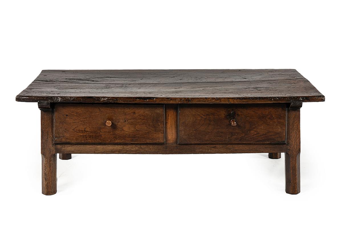 This charming Spanish coffee table is crafted entirely from solid chestnut wood and features a deep, warm brown tone with a beautifully aged patina.
The top is made of two exceptionally wide planks of chestnut and is firmly joined to the base with