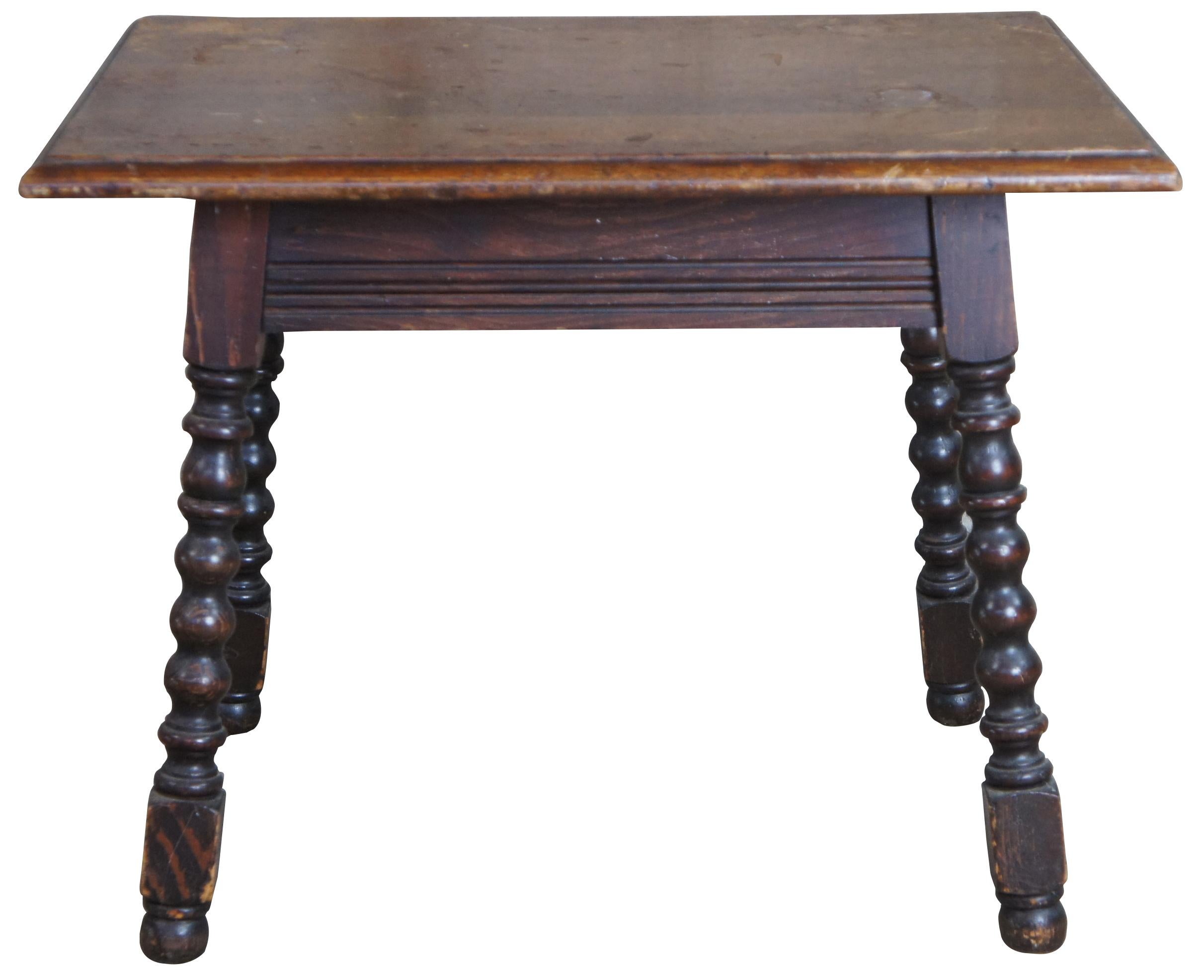 Early 20th century English oak side/end table. Rectangular form with beveled edge, fluted apron, spool turned legs and bun feet. 
 