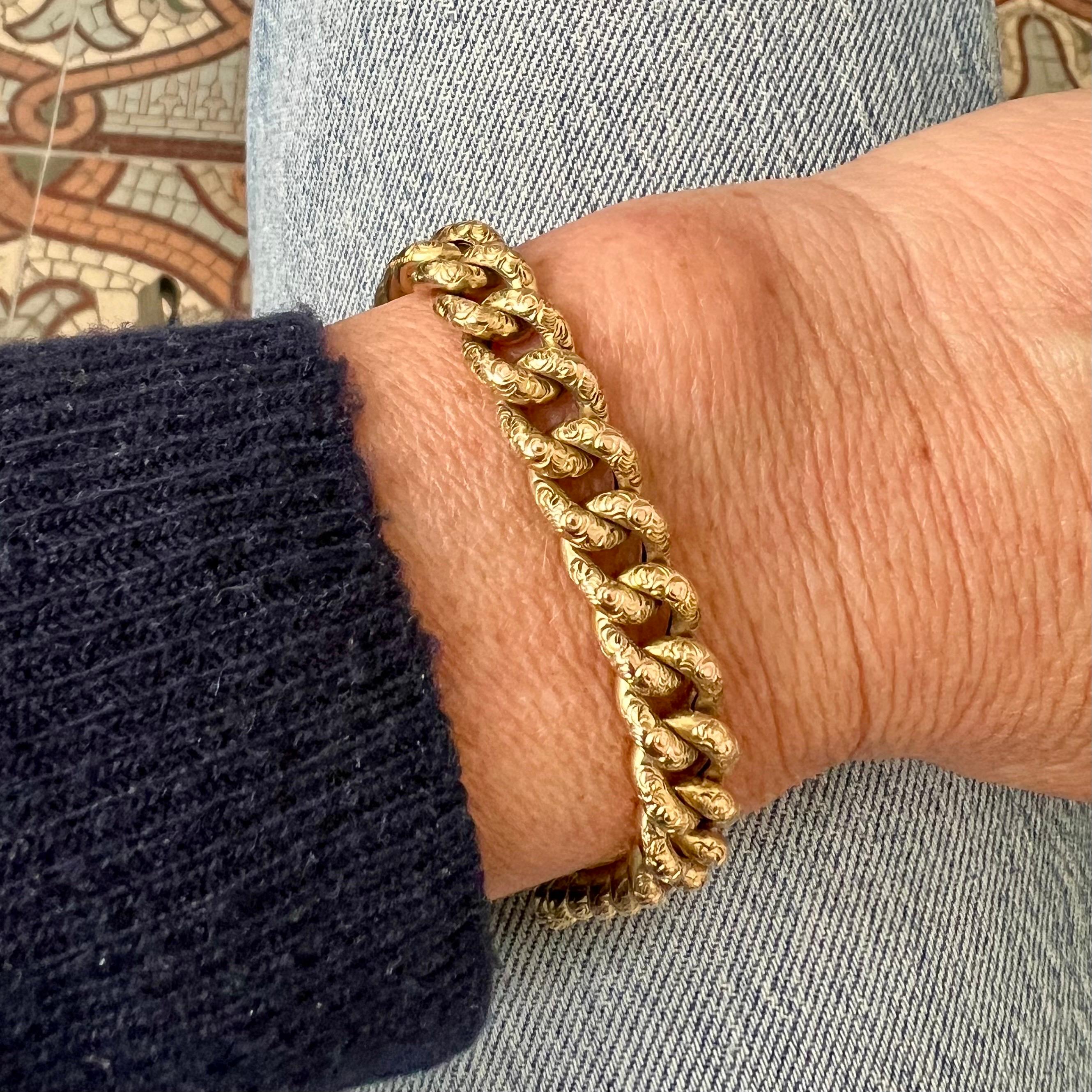 This antique curb chain bracelet is a beautifully preserved piece from the early 20th century, crafted in solid 14 karat yellow gold. It exemplifies the refined craftsmanship and attention to detail characteristic of fine jewelry from the Edwardian