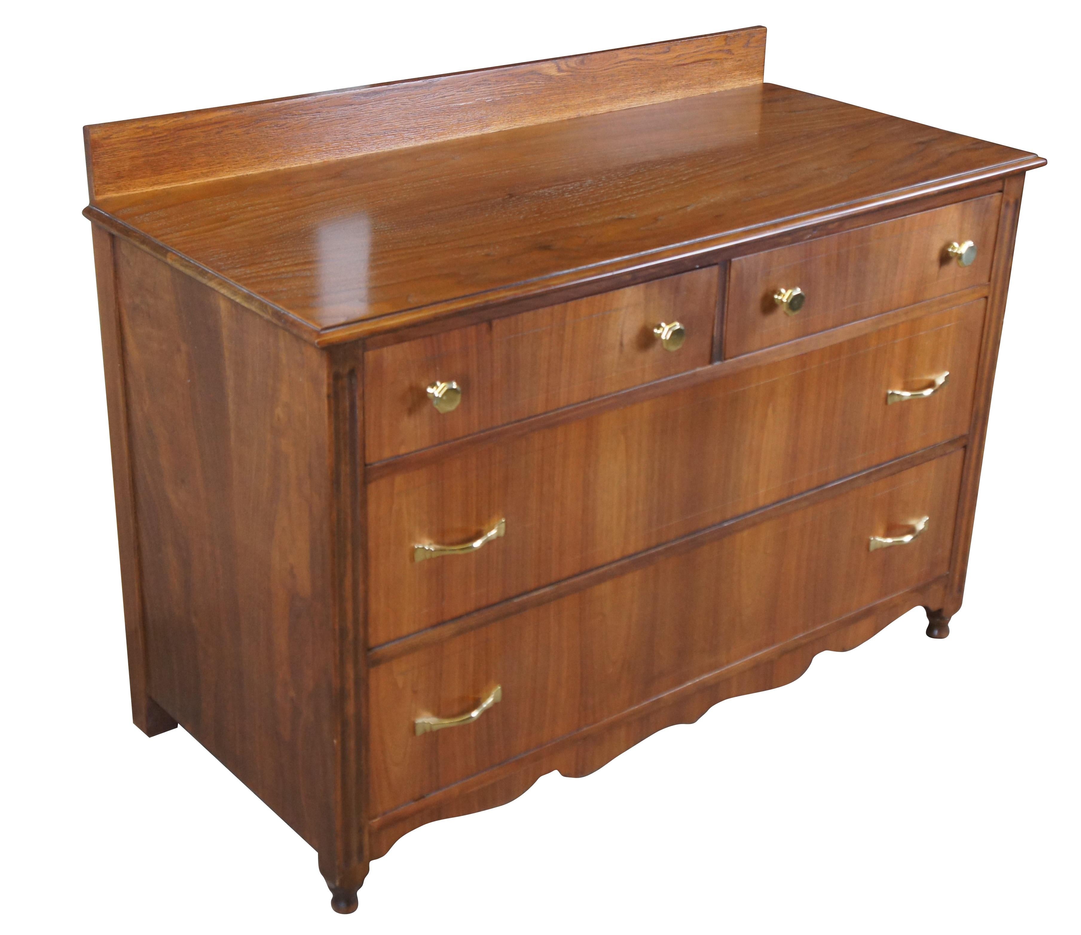 Late Victorian style chest of drawers, circa 1910.  Features a rectangular frame made from American Walnut.  Two over two dovetailed drawer setup with brass pulls.  The dresser features fluted stiles, serpentine lower apron and peg feet. 