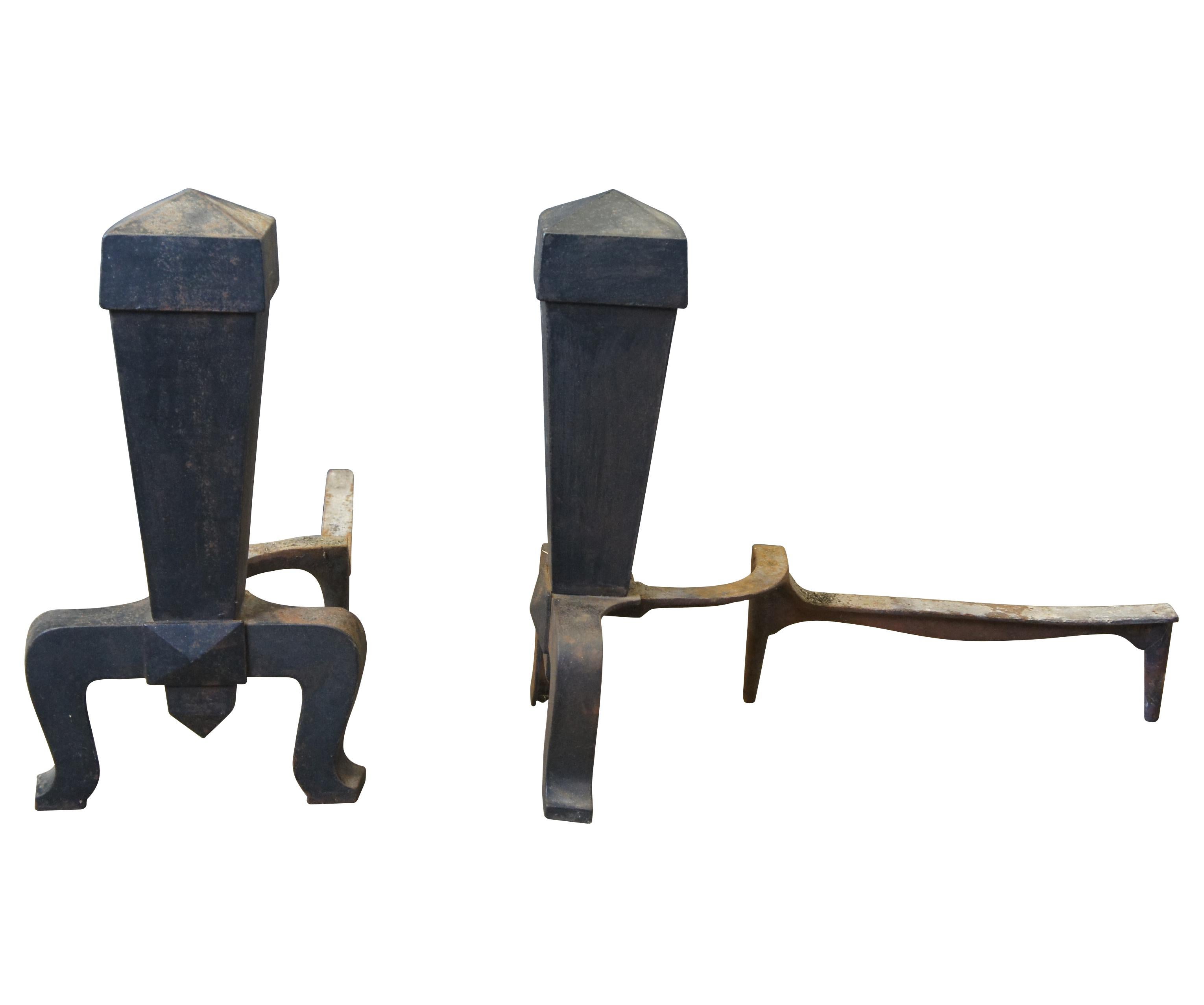 Pair of early 20th century mission or craftsman fireplace andirons. Features a square tapered form leading to a flared leg base. Size: 19