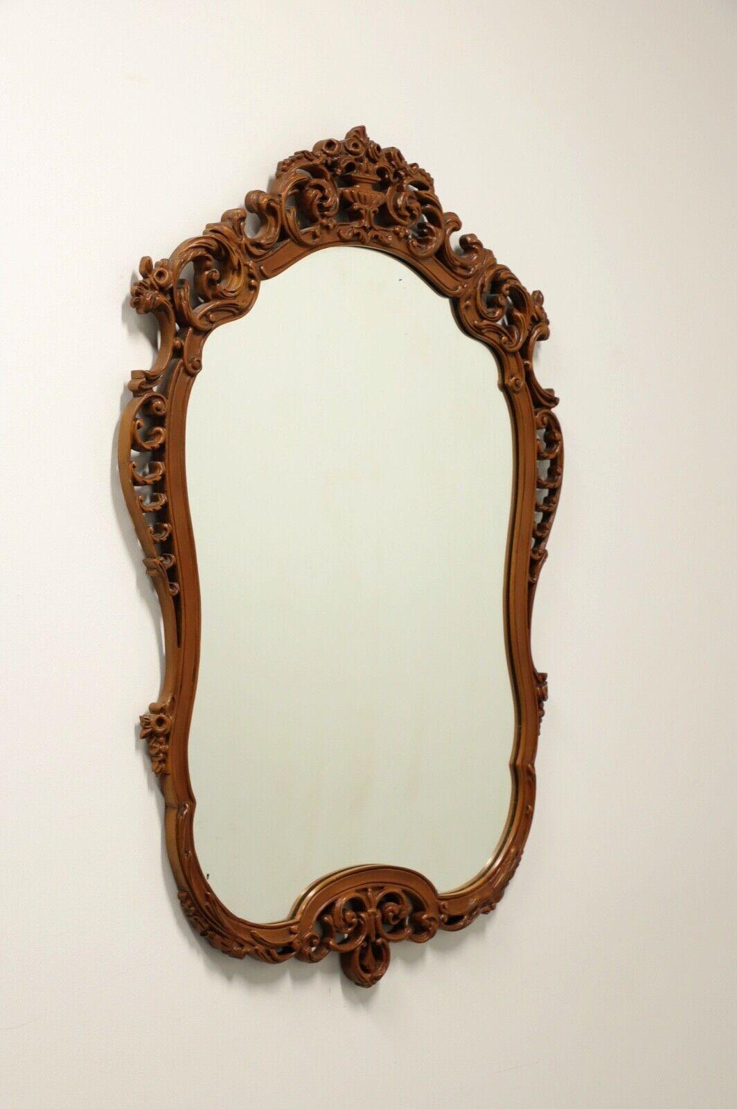 An antique French Country wall mirror, unbranded. Mirrored glass in an intricately carved mahogany frame with a wire hanger. Made in the USA, in the early 20th century.

Measures: 32.5w 1.25d 48h, Weighs Approximately: 30 lbs

Very good antique