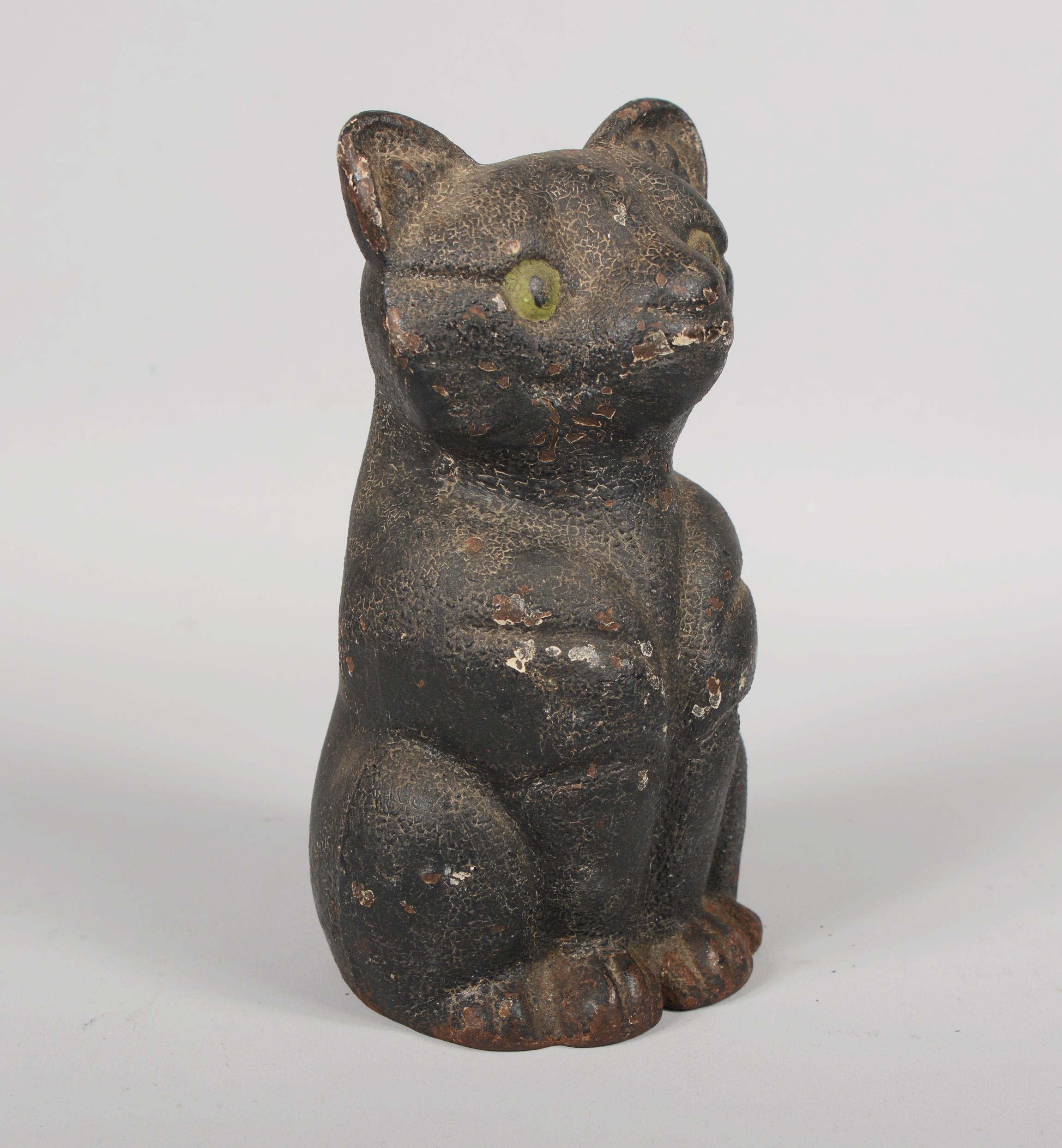 Cast iron black cat door stop. This cat retains the original paint with great crazing and lots of patina.