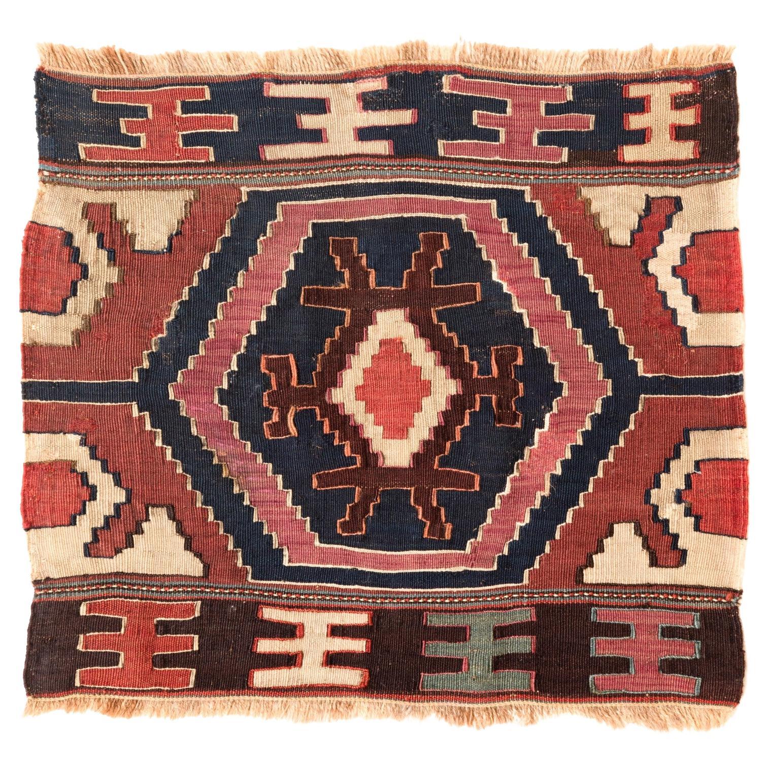 This is an antique collectible Early 20th century Kilim Woven Cradle Part from the Caucasus region with a rare and beautiful color composition.

Of the four countries that make up the Caucasus, Azerbaijan produces the most kilims, and the land has