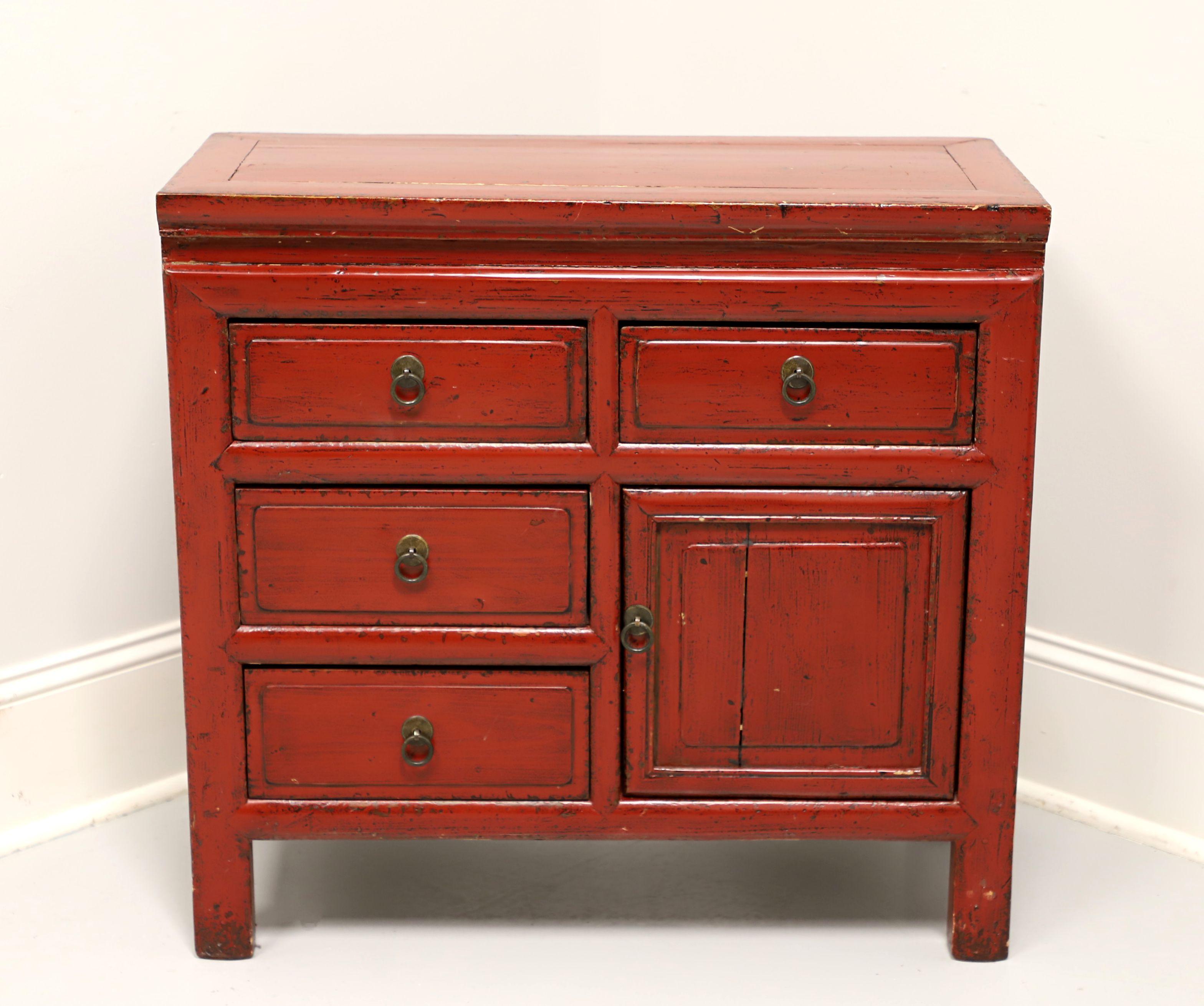 An antique Asian Chinoiserie style console cabinet, unbranded. Solid fir painted red, banded top, metal hardware, and block feet. Features two upper drawers over two lower drawers and a side one door cabinet revealing storage. All drawers are of
