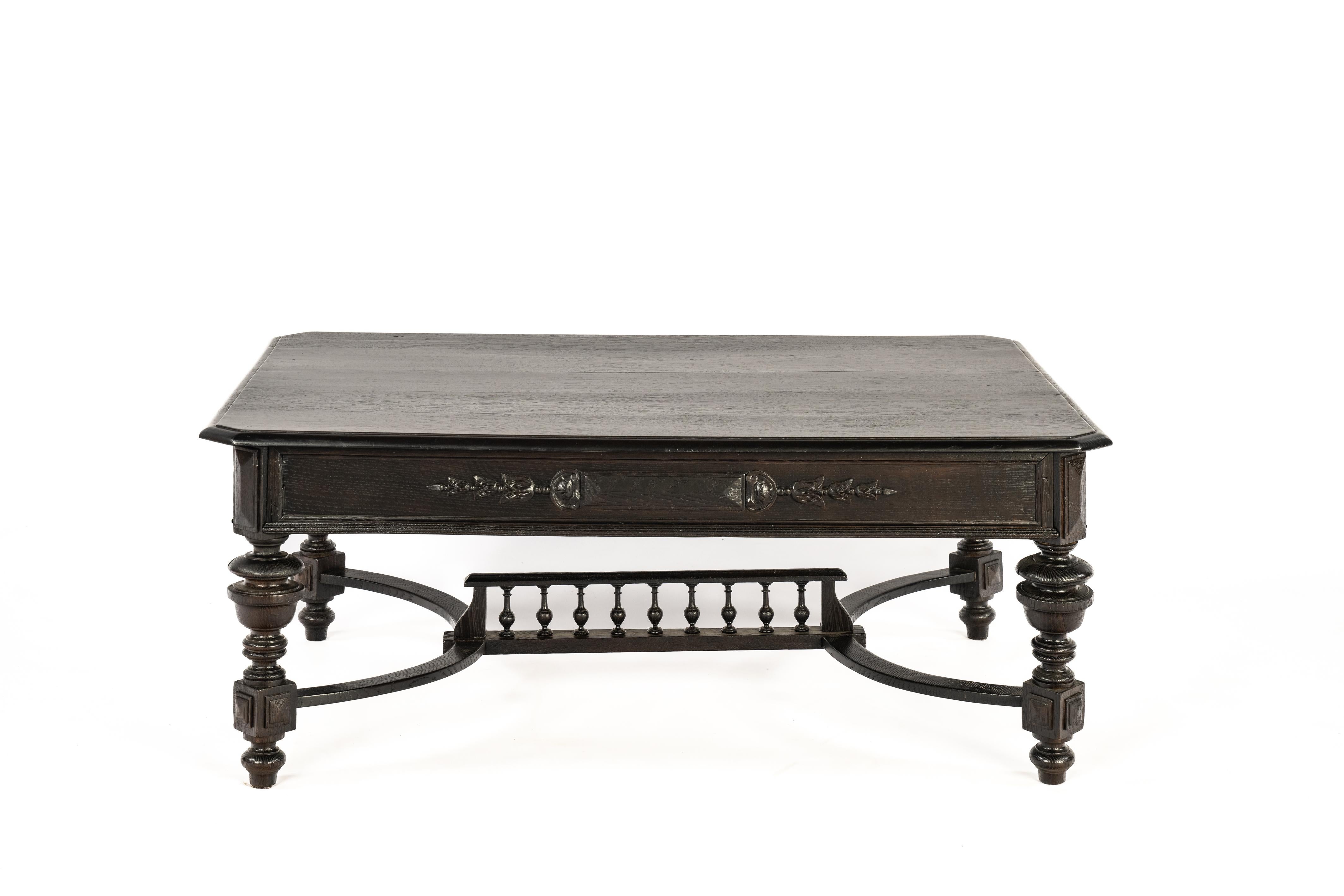 On offer here is a neo-classical coffee table that was made in France in the early 20th century, circa 1910. The table was made in the finest quality European summer oak, was stained in a dark brown color and finished with a deep gloss. Over the