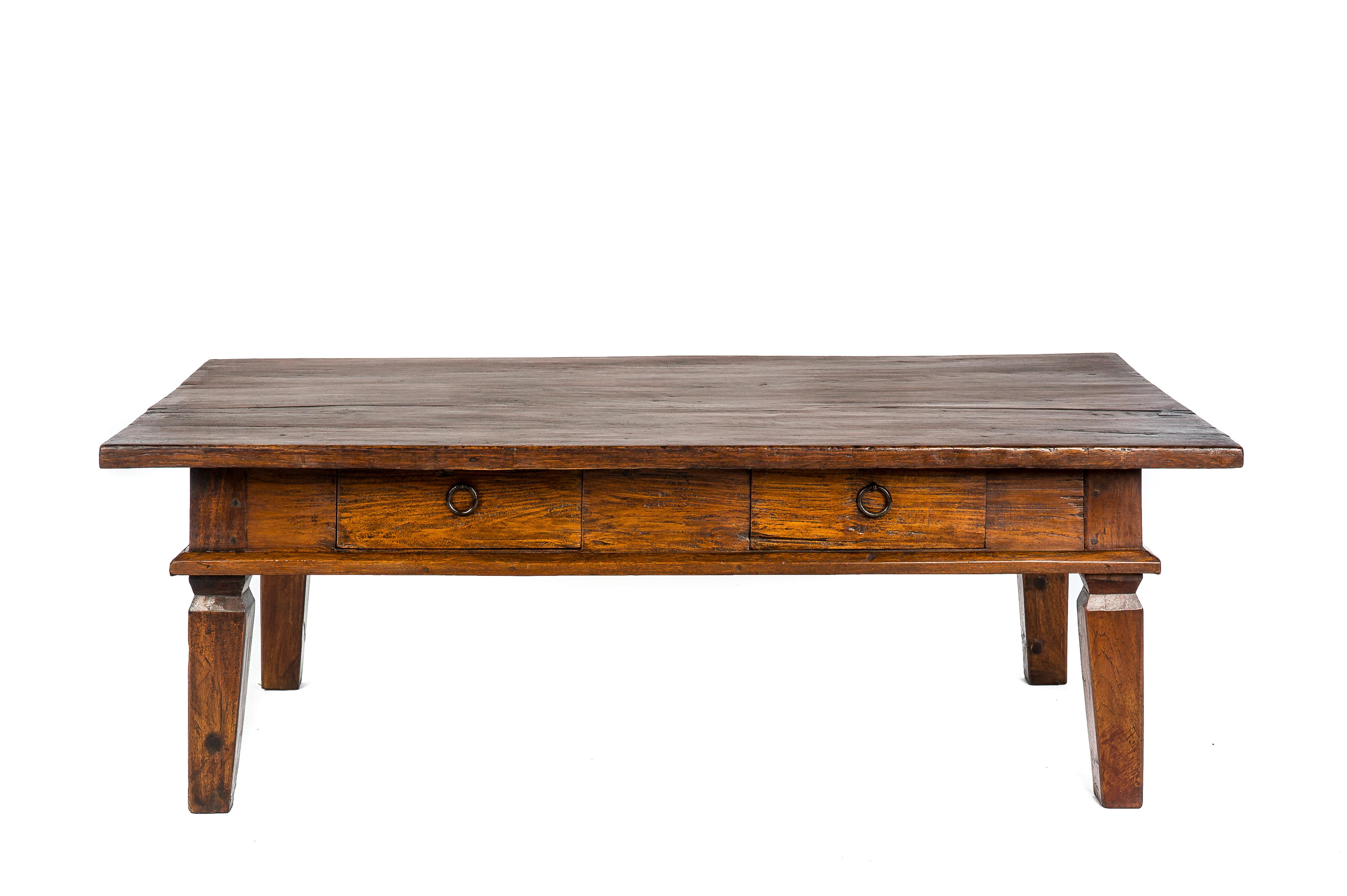 This robust coffee table was made in the Netherlands in the early 20th century. The table was completely made in solid Indonesian teak wood with a beautiful grain pattern. This unique top was made from a single board of teakwood. The table features