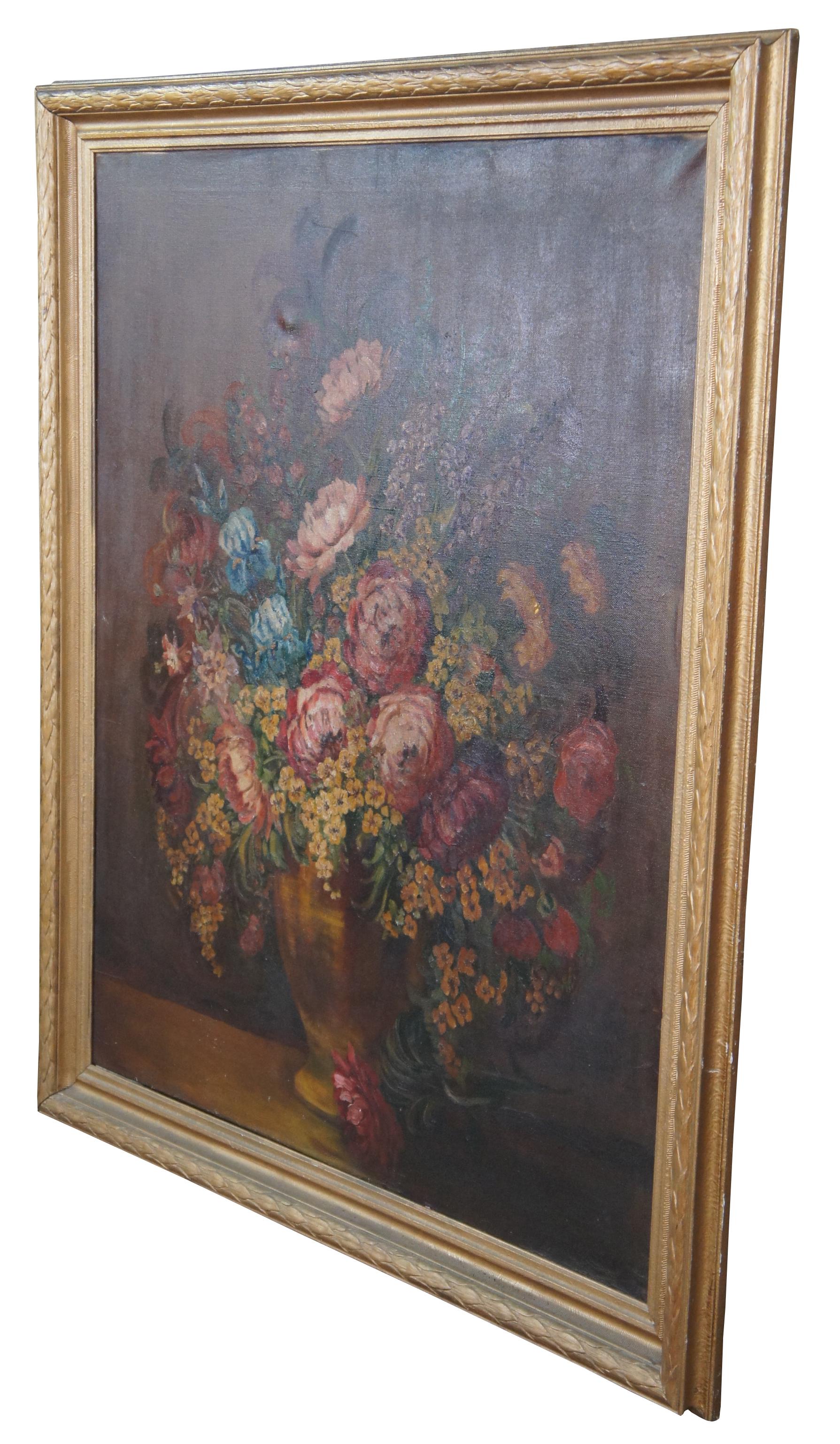 Antique early 20th century floral still life oil painting on canvas featuring a bouquet of flowers in a gold vase with French frame framed.

Measures: 46