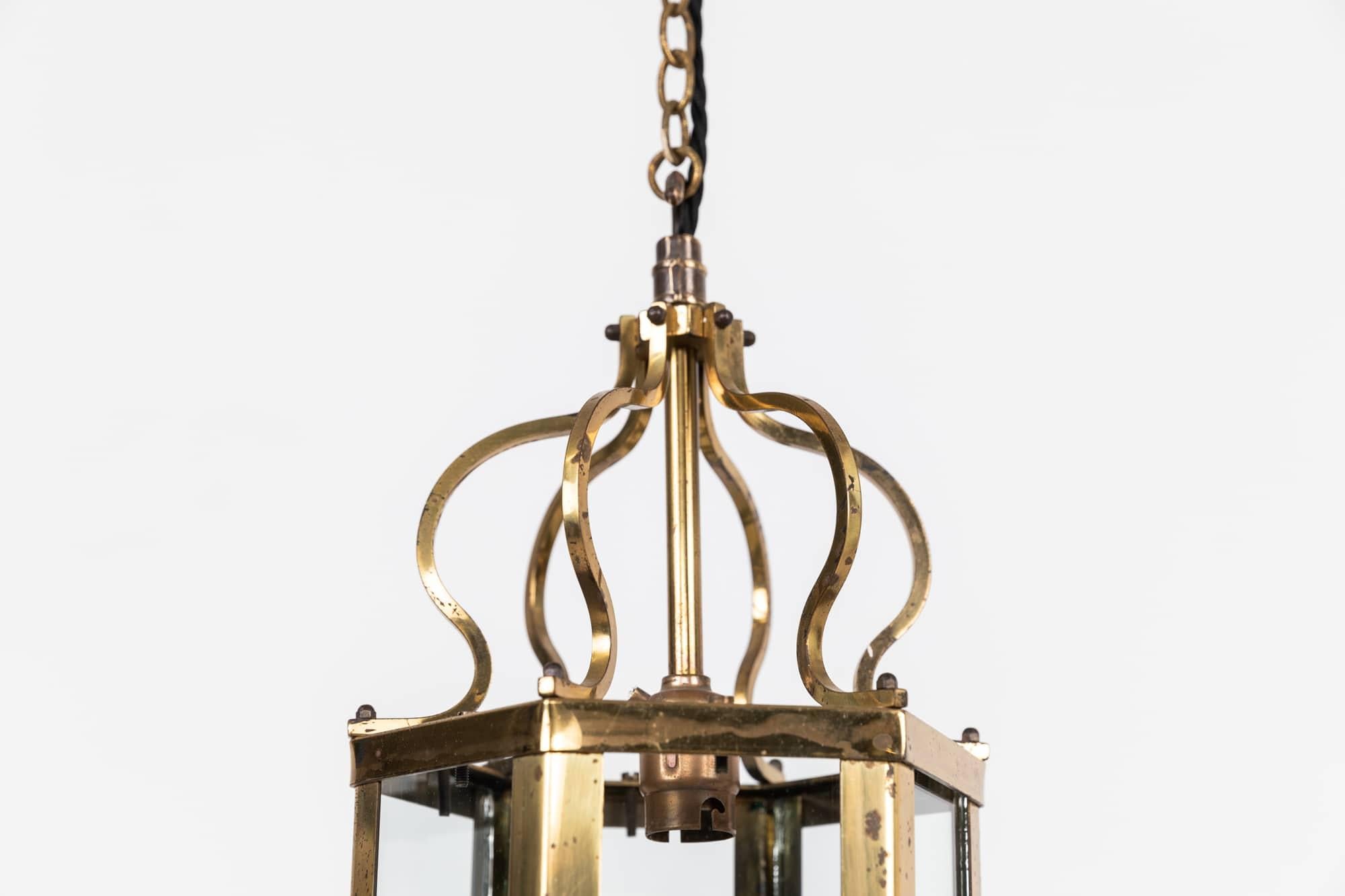 

A beautifully formed diminutive arts & crafts brass porch lantern. c.1920

Simply formed from brass, with glazed panels all original and intact. 
